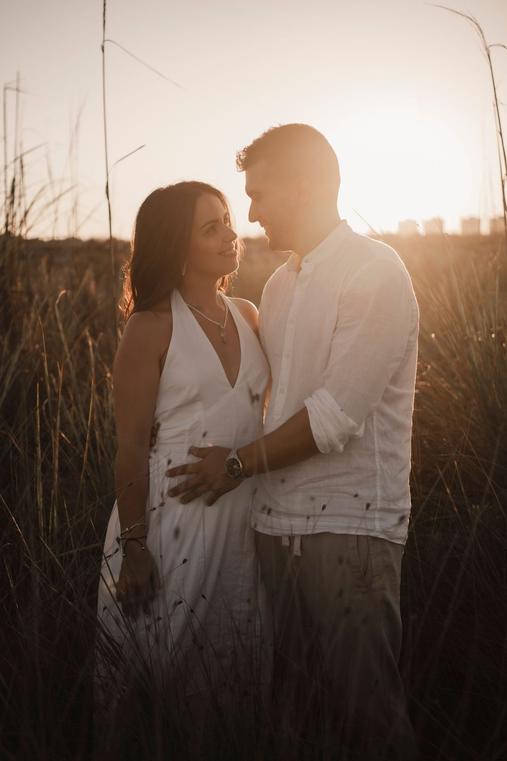 Cinematic destination pre-wedding session with dramatic coastal lighting and reflections.