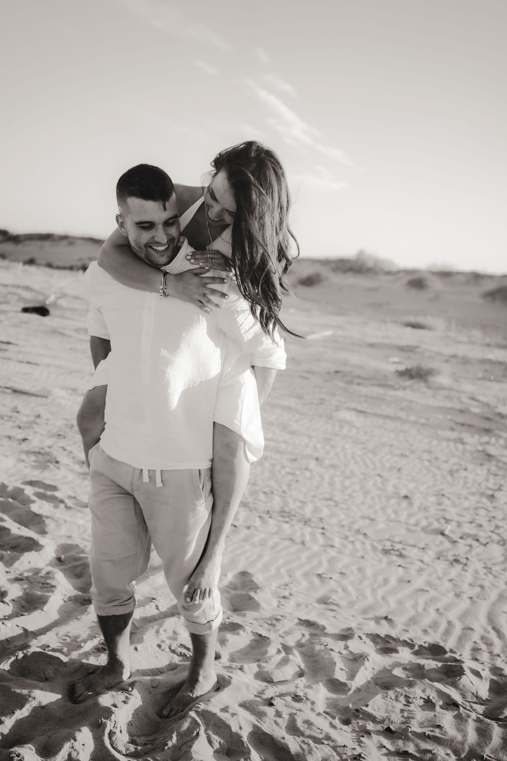 Editorial pre-wedding photography featuring an elegant couple in the sand dunes of Venice Lido.