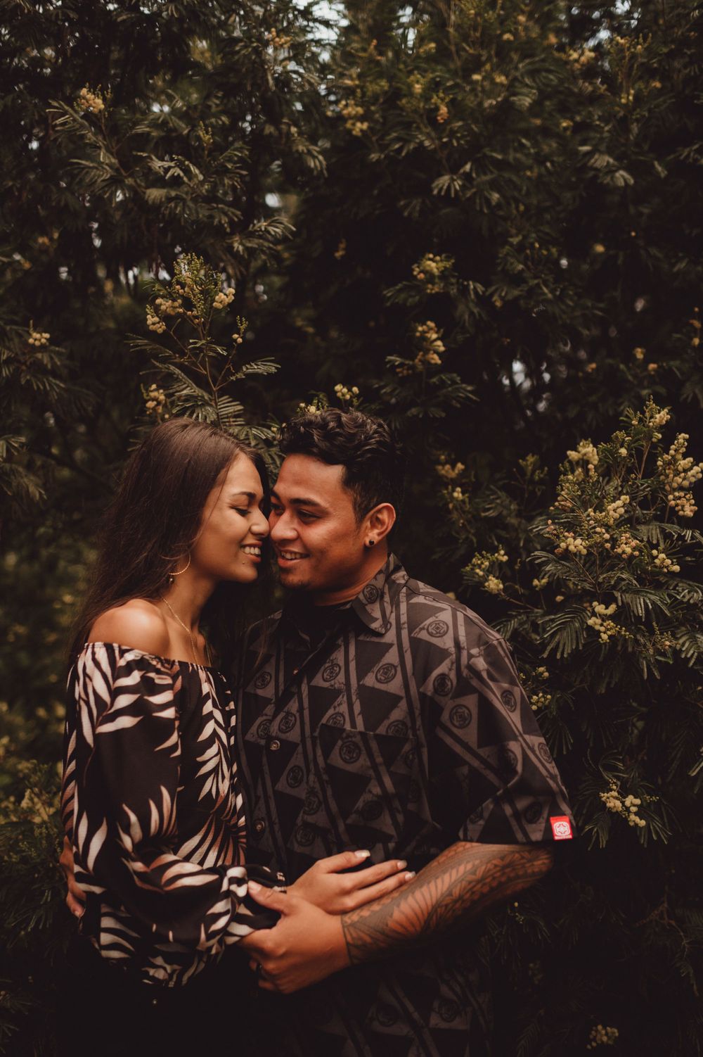 Couple shares intimate moments surrounded by autumn foliage and natural light.