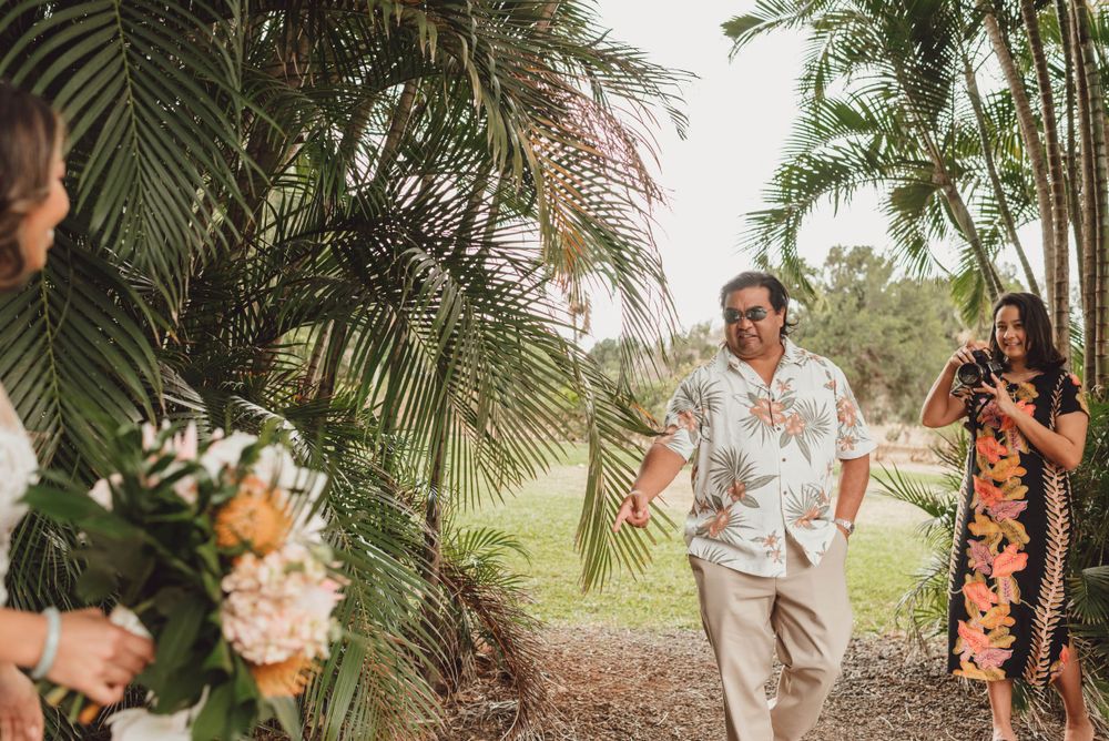 Tropical garden wedding setting with palm trees and natural landscaping creating a romantic atmosphere.