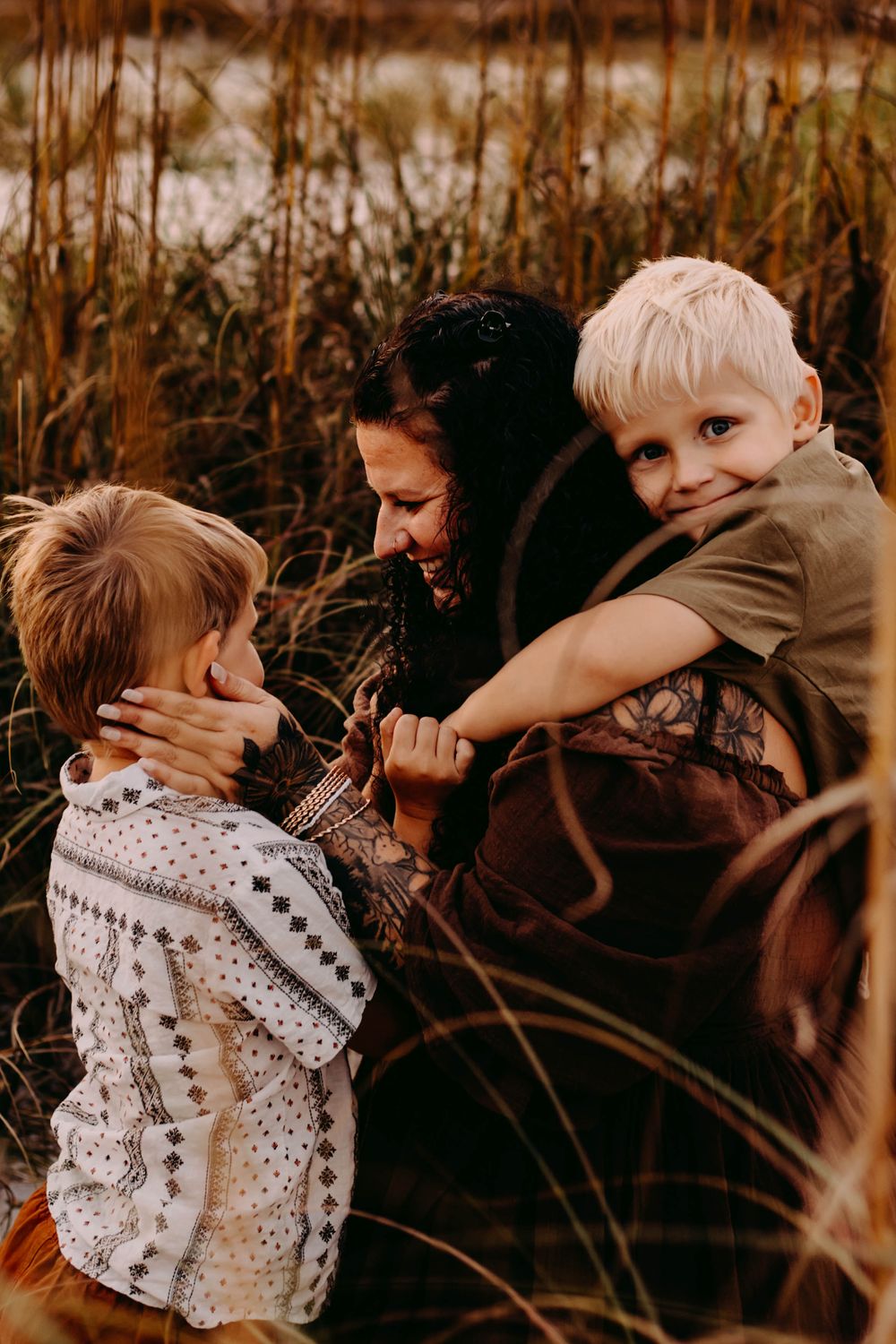 A series of candid moments captured in warm autumn tones showing affectionate embraces between people outdoors.