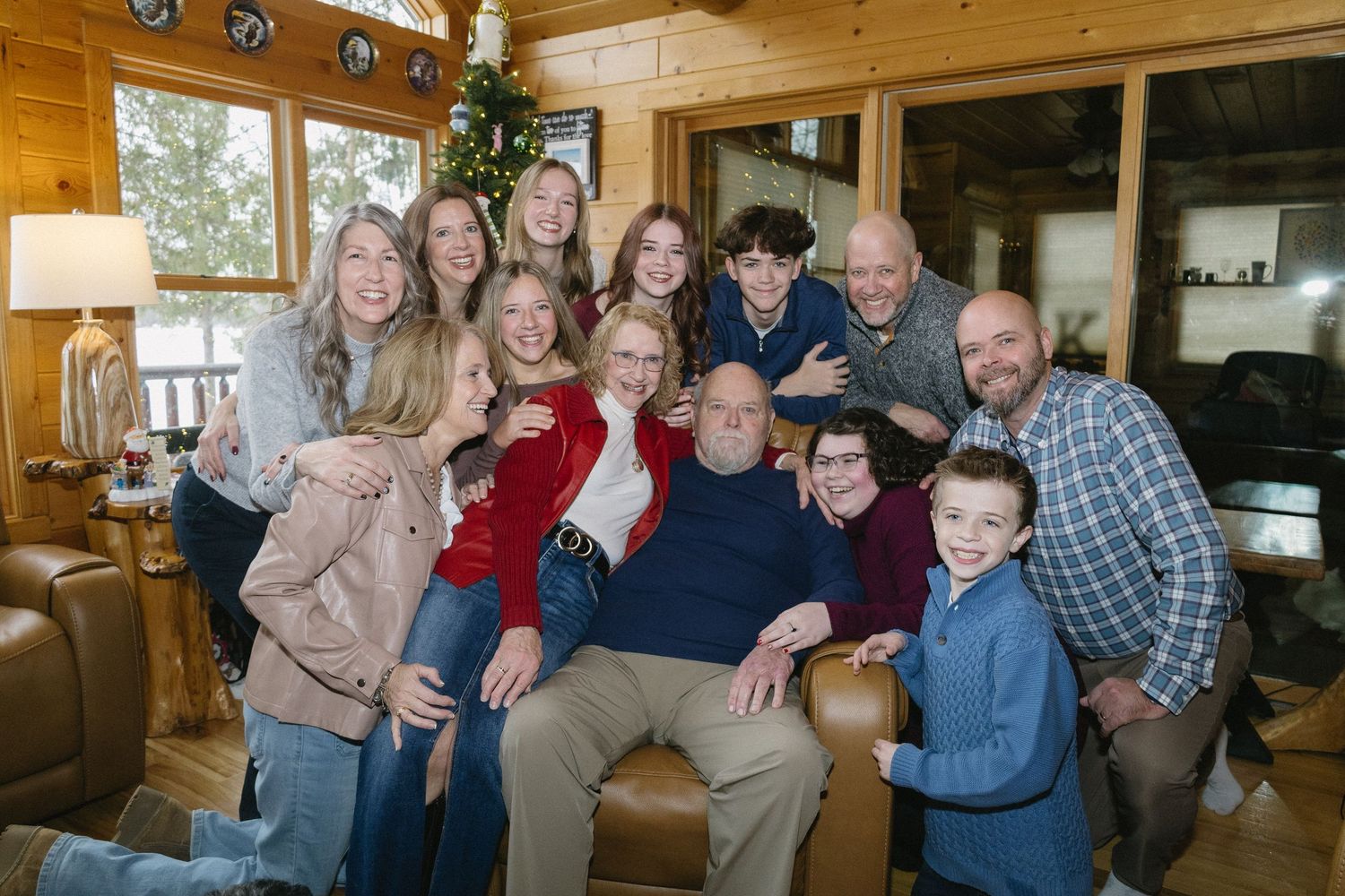 A large family smiling in their cabin for family portraits.
