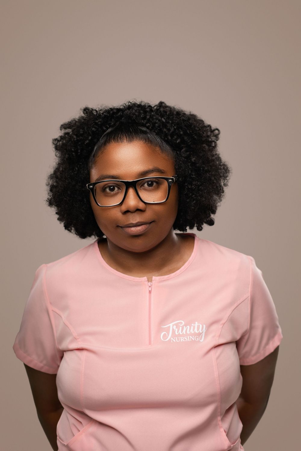 Person wearing glasses and pink t-shirt with curly hair shown in multiple poses against neutral background.