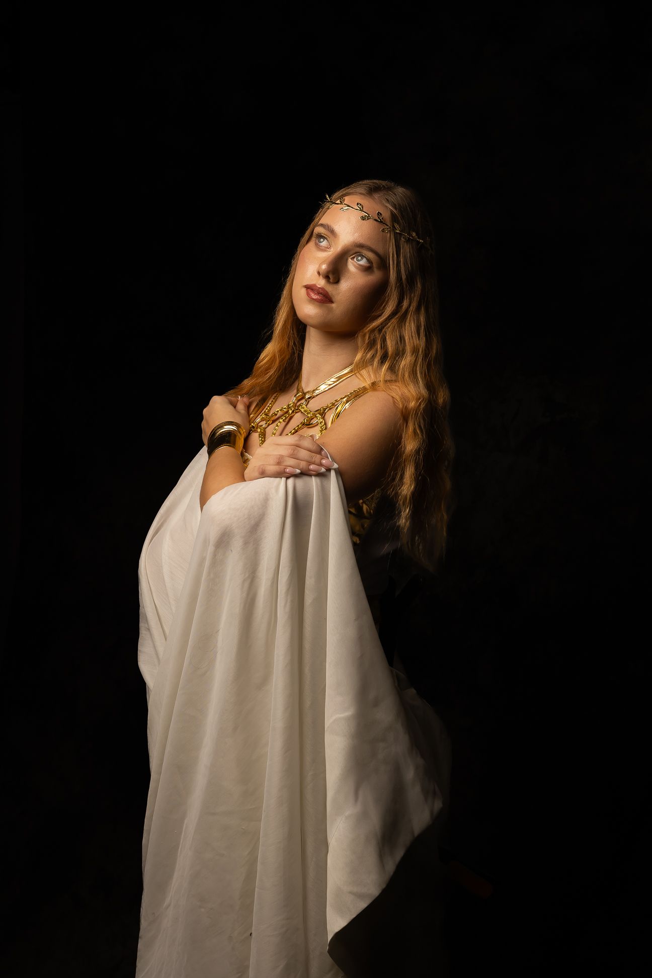 Hippolyta, Queen of the Amazons, girl in white staning looking straight, black background