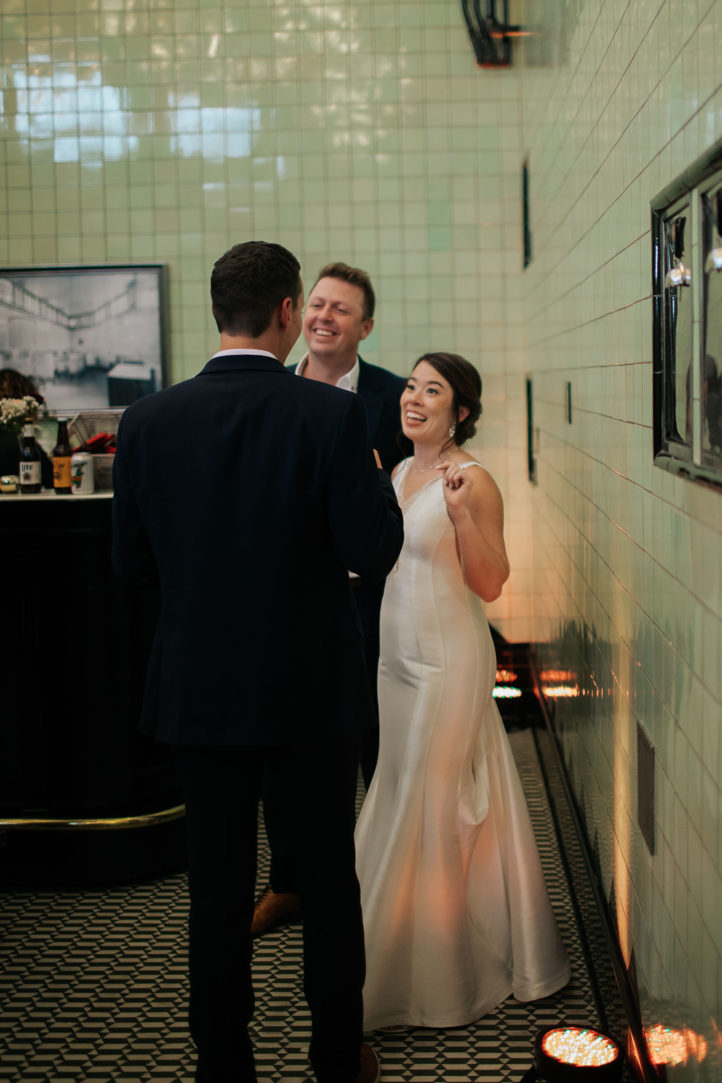 A series of romantic wedding moments captured against a tiled wall with dramatic lighting and shadows.