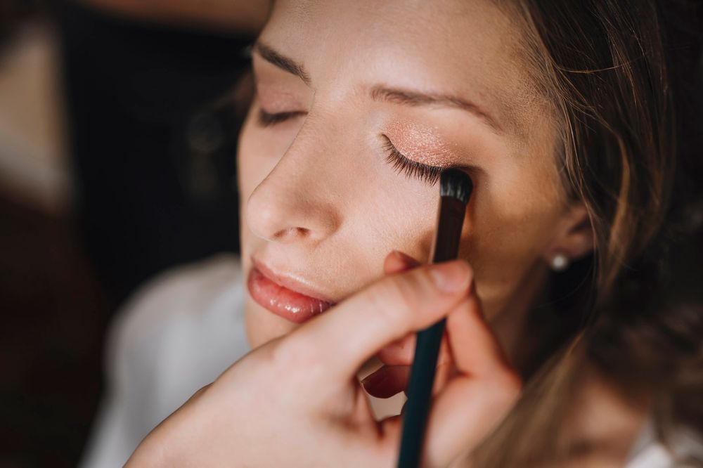 Close-up beauty shot showing makeup application and red lipstick.