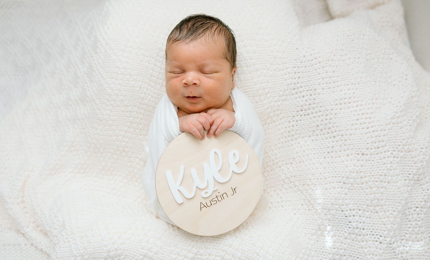 Newborn baby lying in a basket during a newborn photography session.