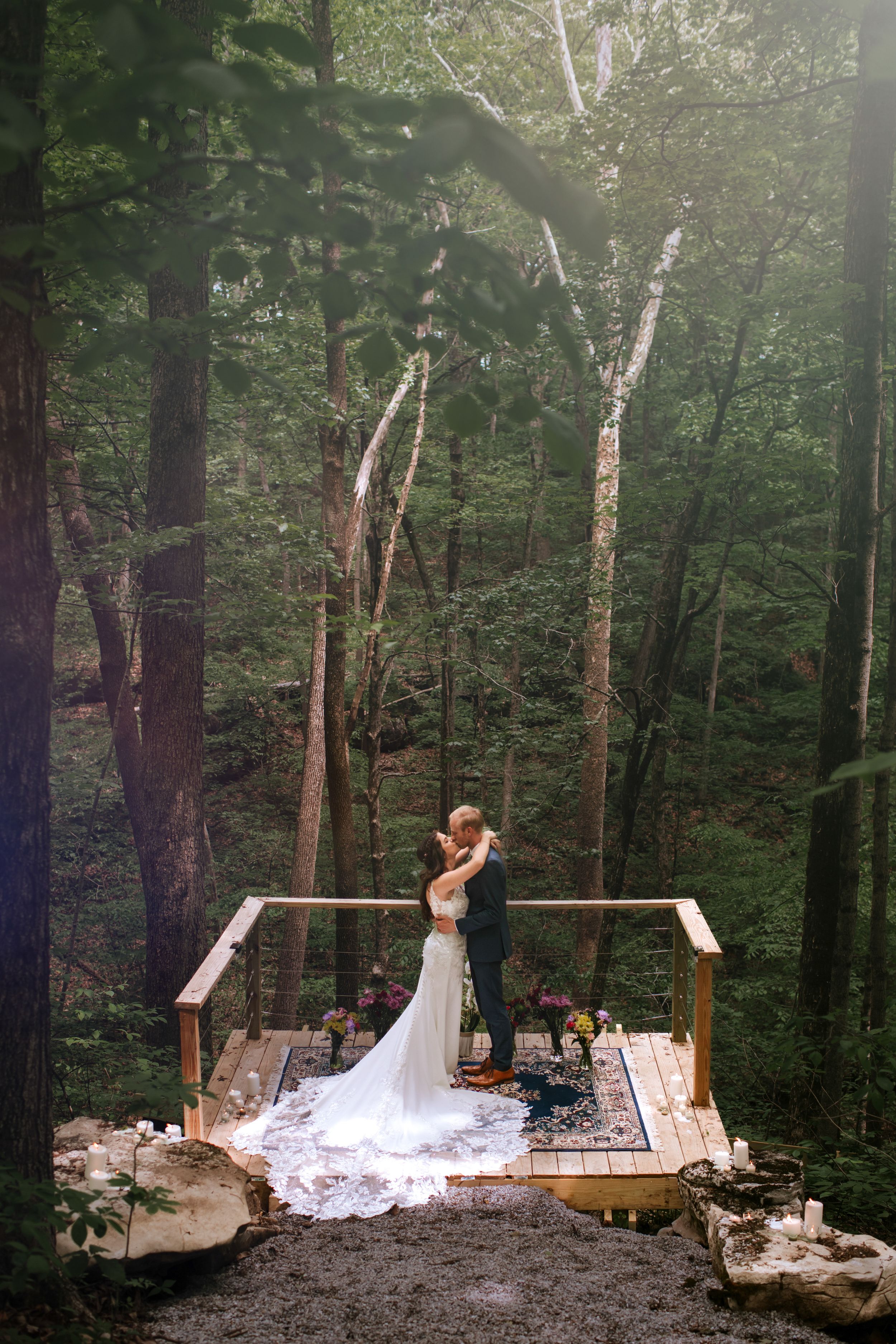 Wedding ceremony in a magical forest setting with sunlight streaming through the trees.