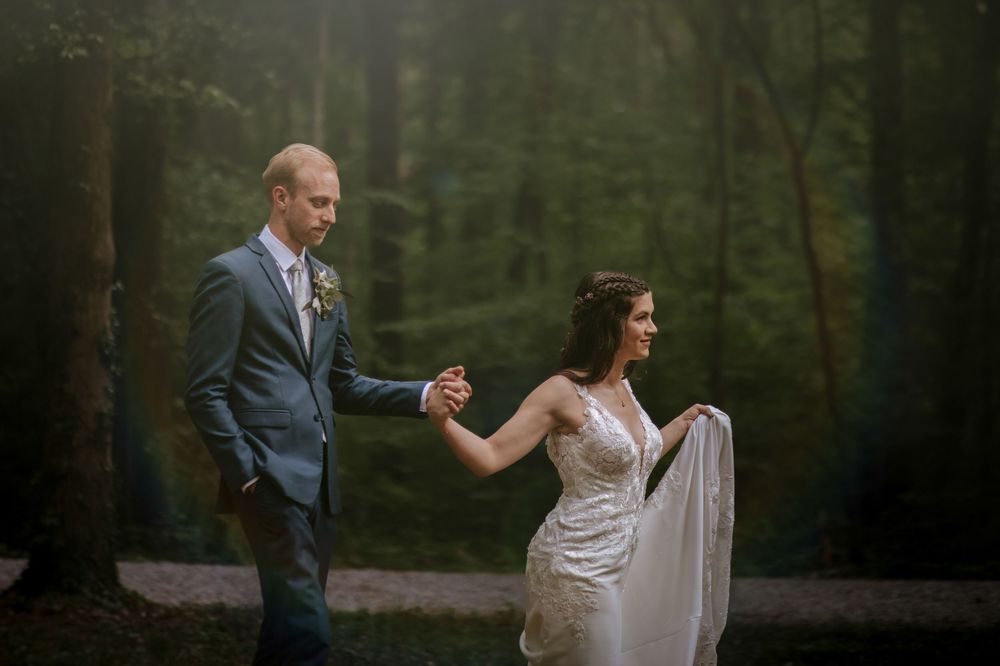Couple sharing romantic moments during their forest wedding photoshoot.