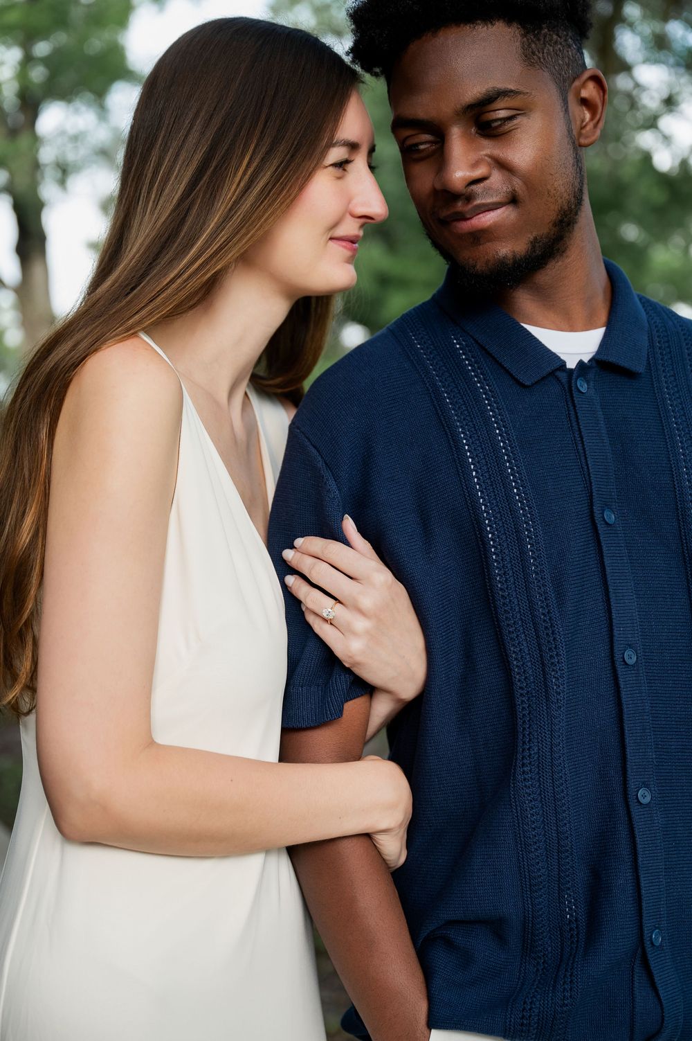 Intimate close-up shots of a couple sharing romantic moments in a park setting.