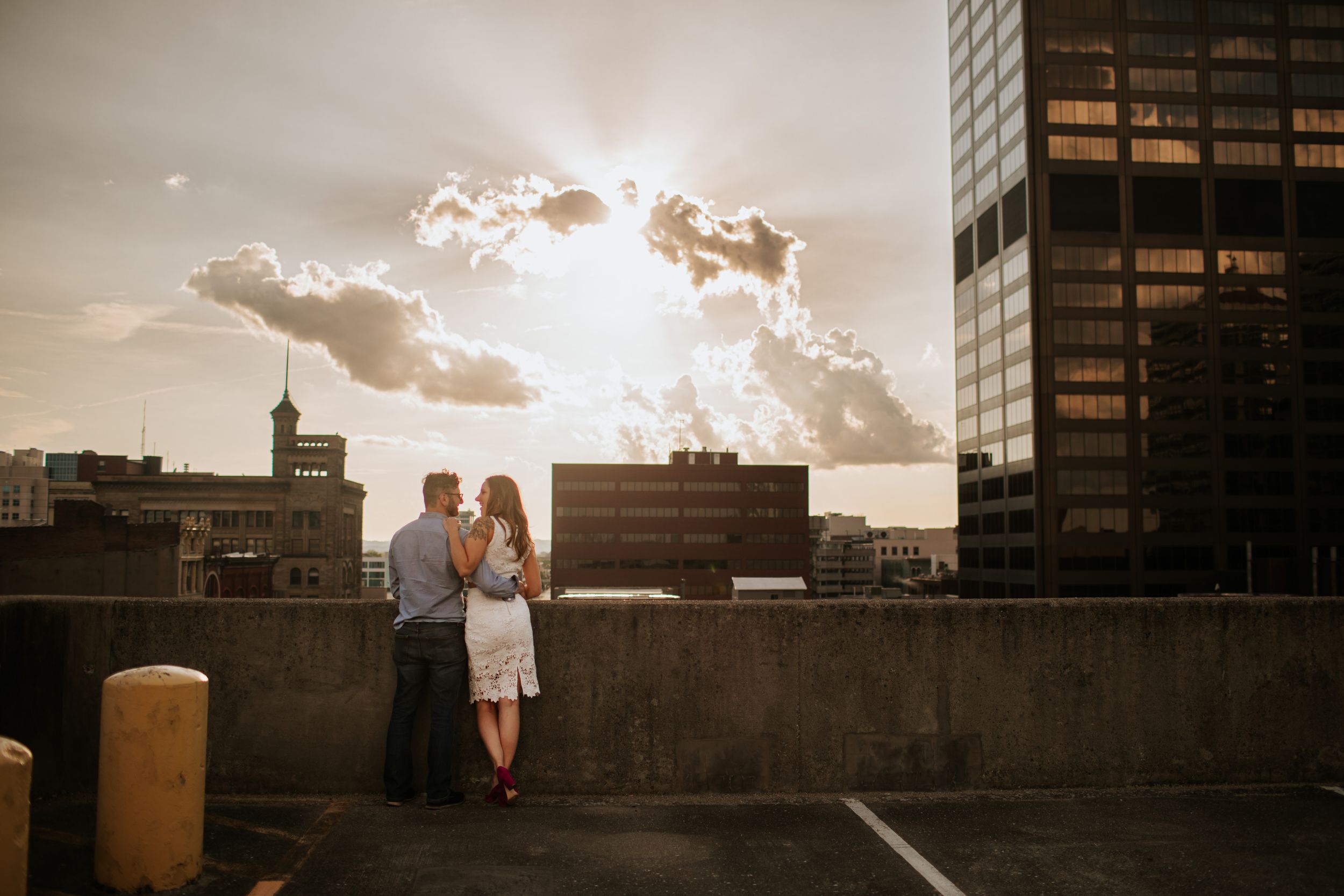 A dramatic cityscape silhouette at sunset creates a romantic urban backdrop.