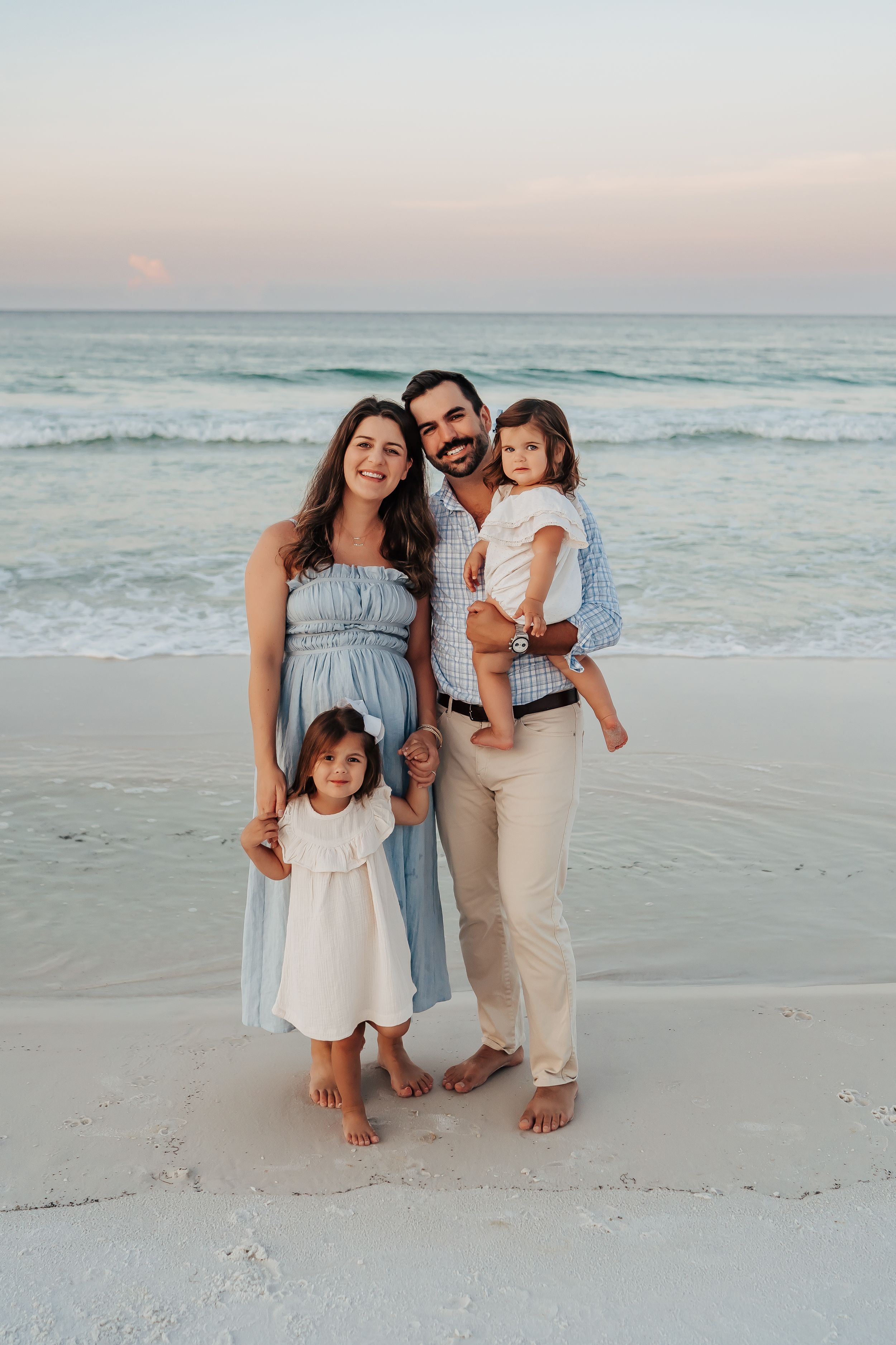 Sunrise family photo session on 30A beach with soft pastel sky