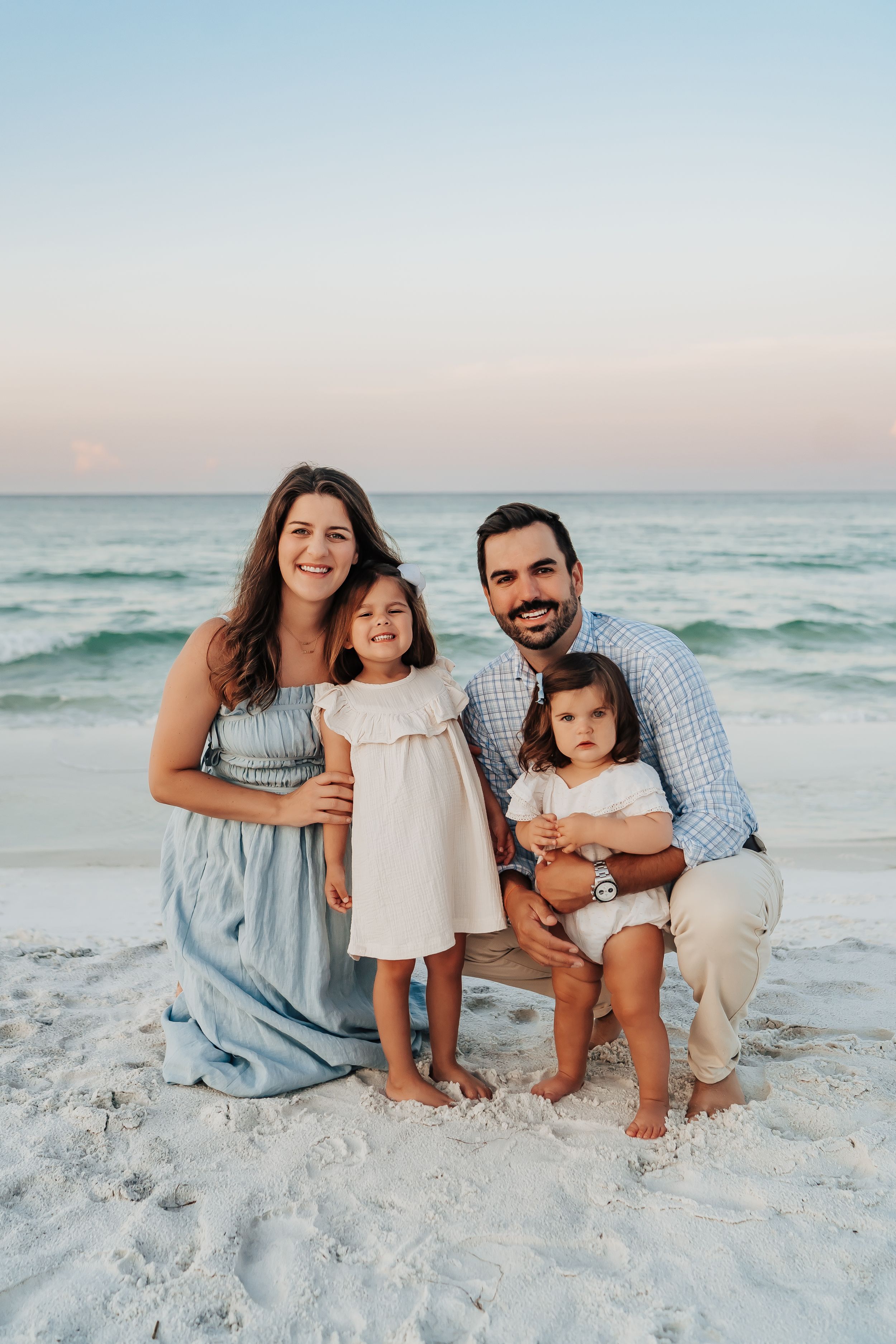 Sunrise family photo session on 30A beach with soft pastel sky