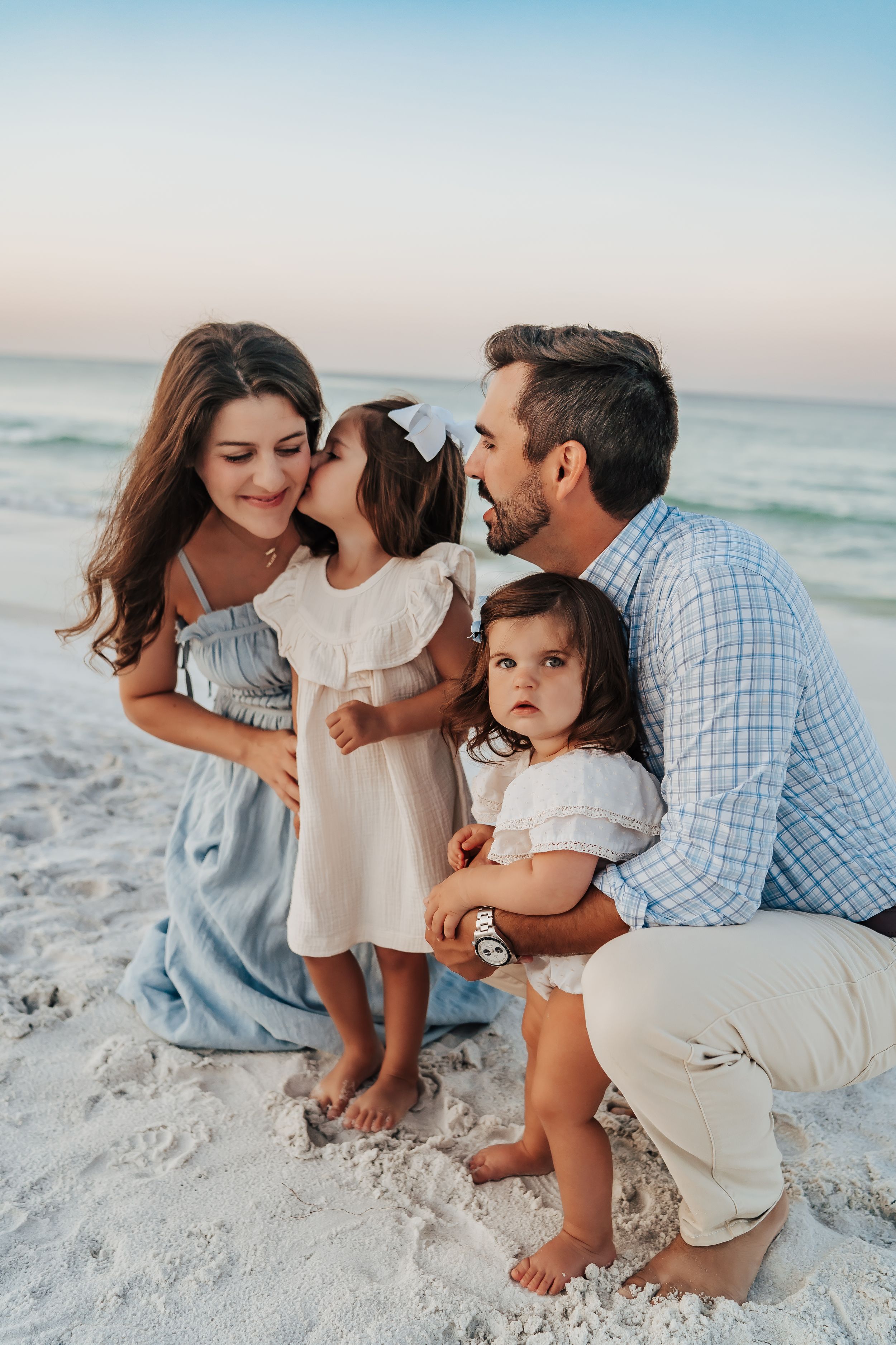 Sunrise family photo session on 30A beach with soft pastel sky