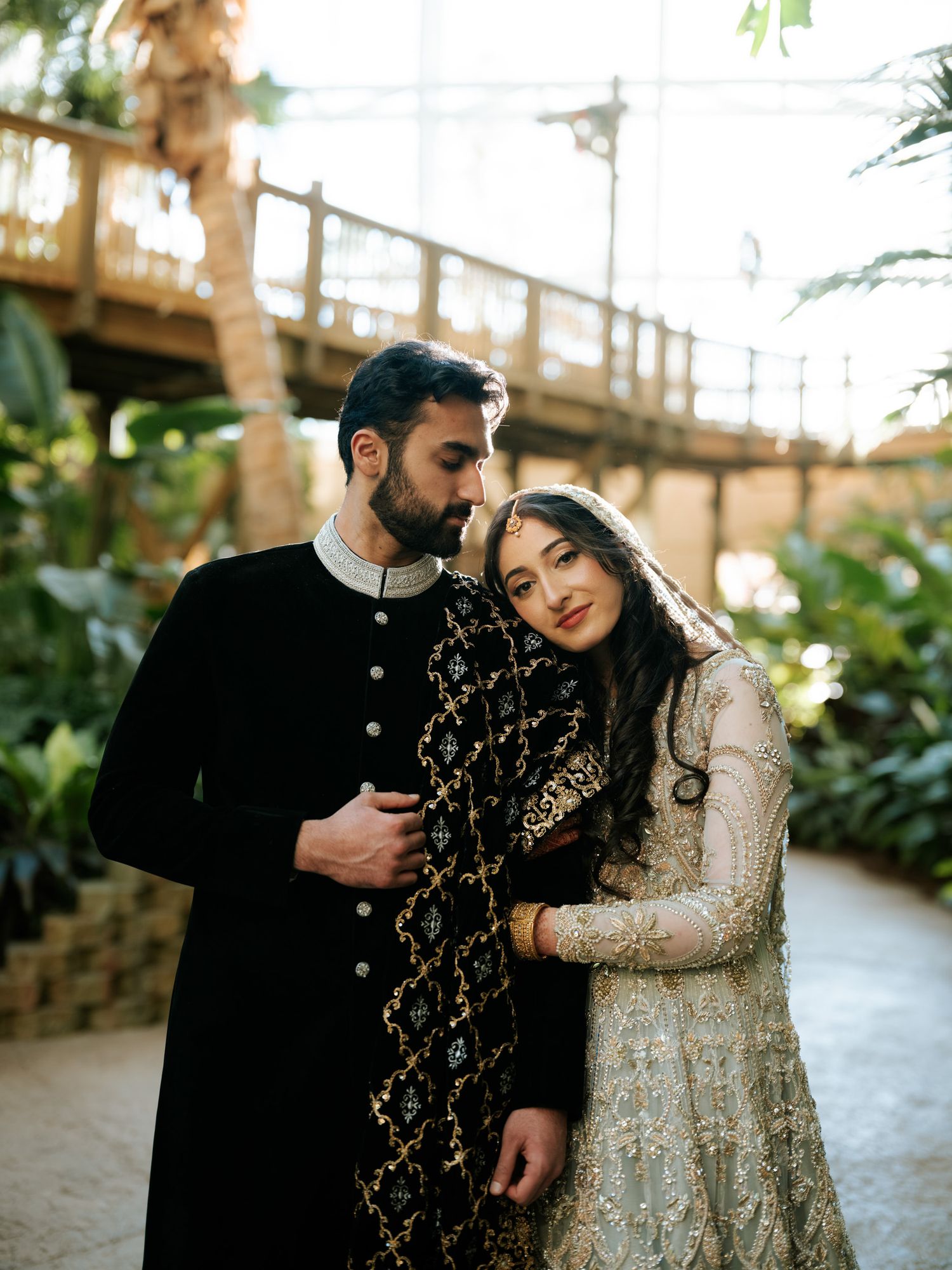 A couple in traditional South Asian wedding attire share intimate moments in a series of romantic outdoor portraits.