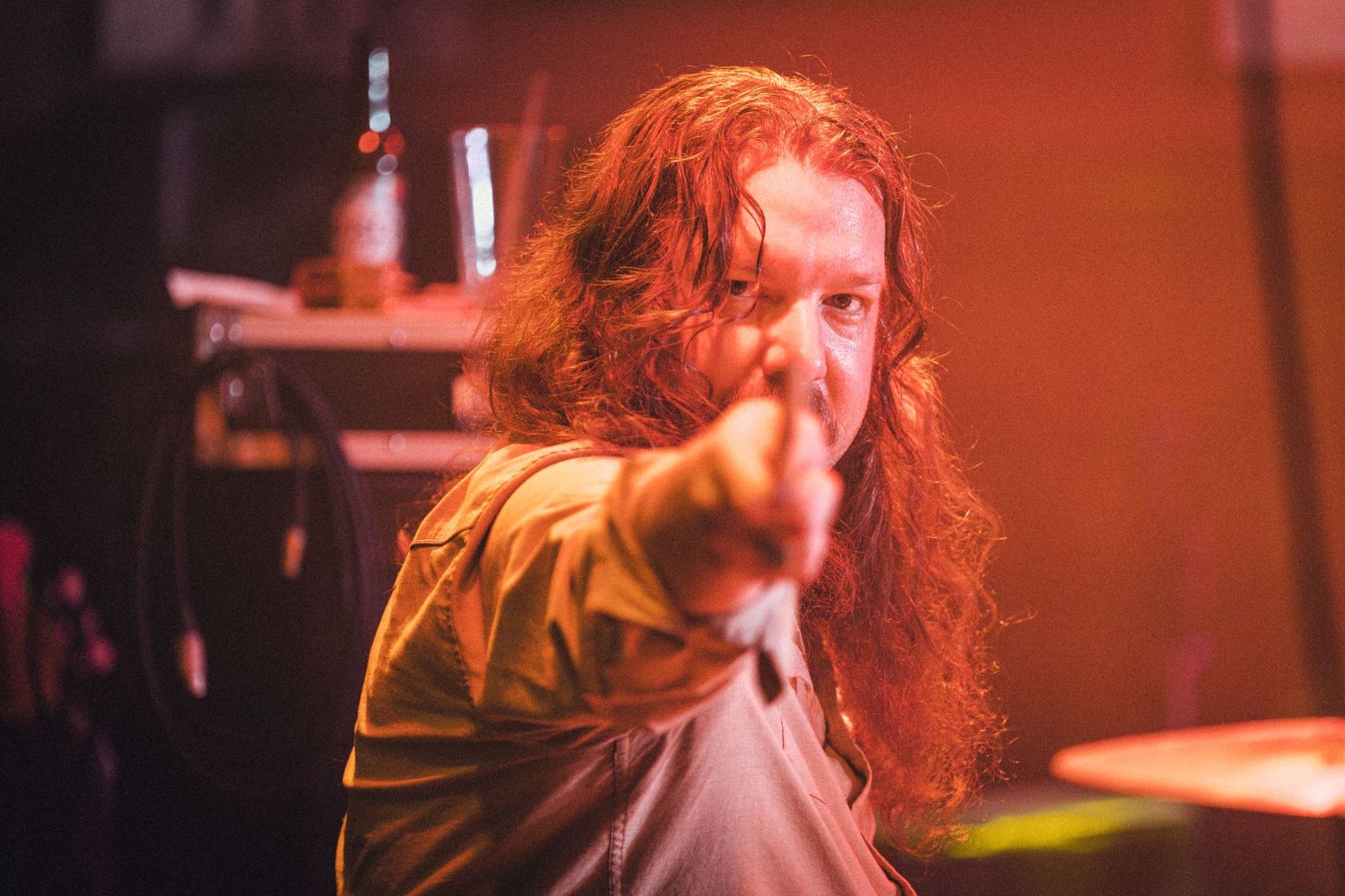 Concert performance photos with dramatic red lighting and stage effects. live event photography st louis.
