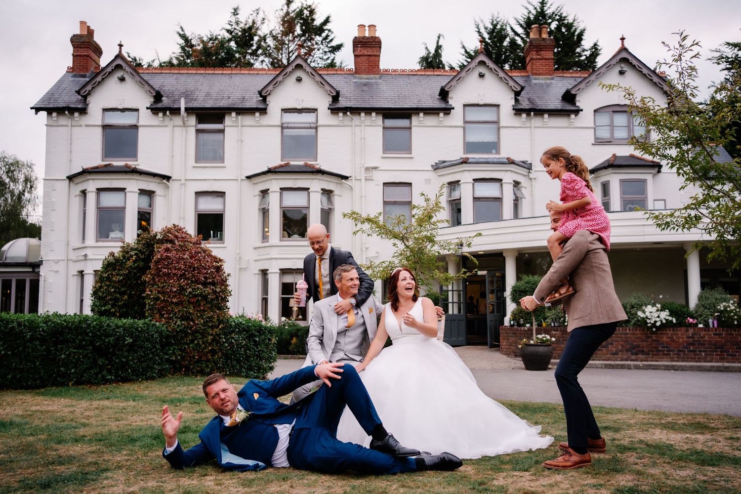 Couple with fun guests enjoying photo roulette together at Southdowns manor