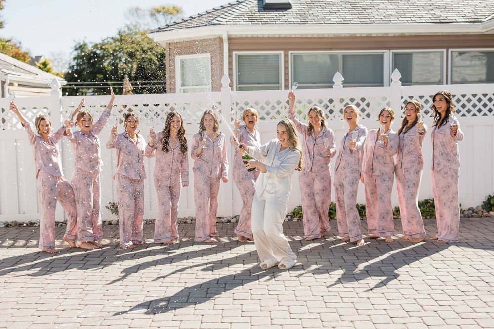 Alex and her bridesmaids pop some champagne before getting ready at a private home in Manasquan, New Jersey.