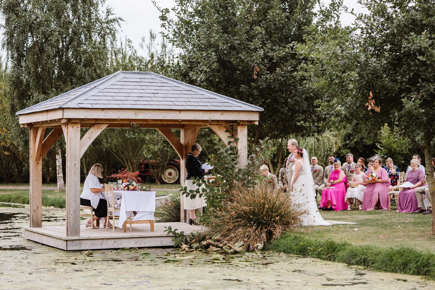 Outdoor wedding at Waterside Country Barn and Mill, Taunton Outdoor Barn wedding venue with lake. Candid wedding photographer Somerset