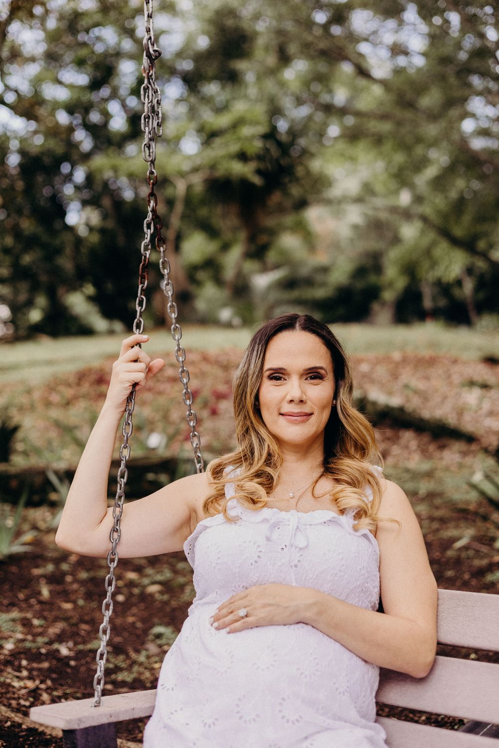 A series of outdoor portrait shots on a wooden swing with autumn foliage in the background.