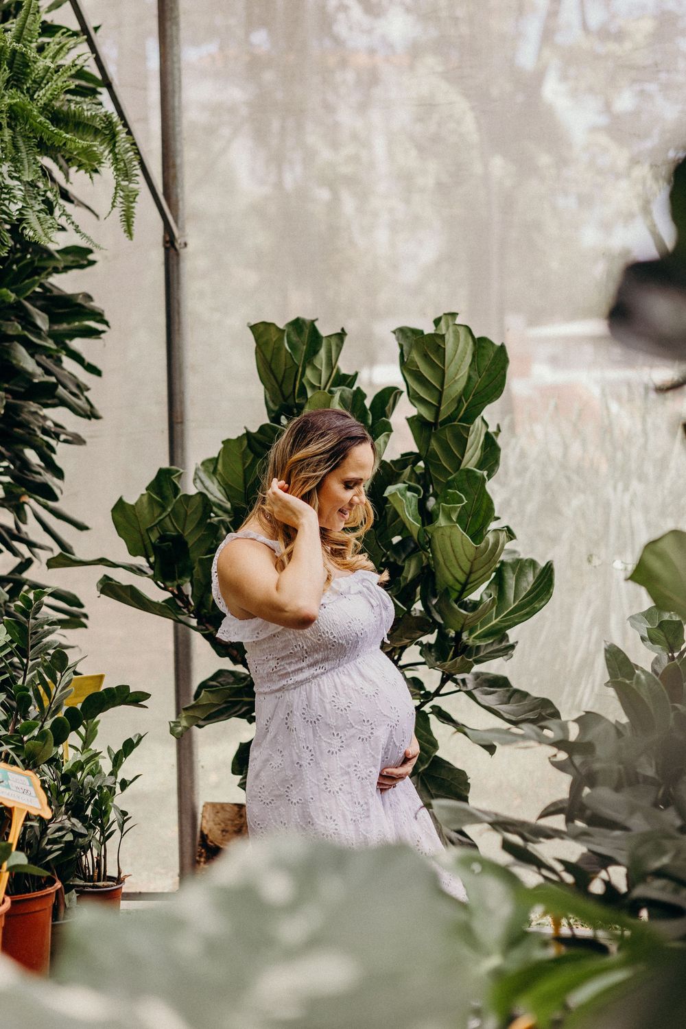 A series of indoor portraits surrounded by lush green plants and natural light in a greenhouse setting.