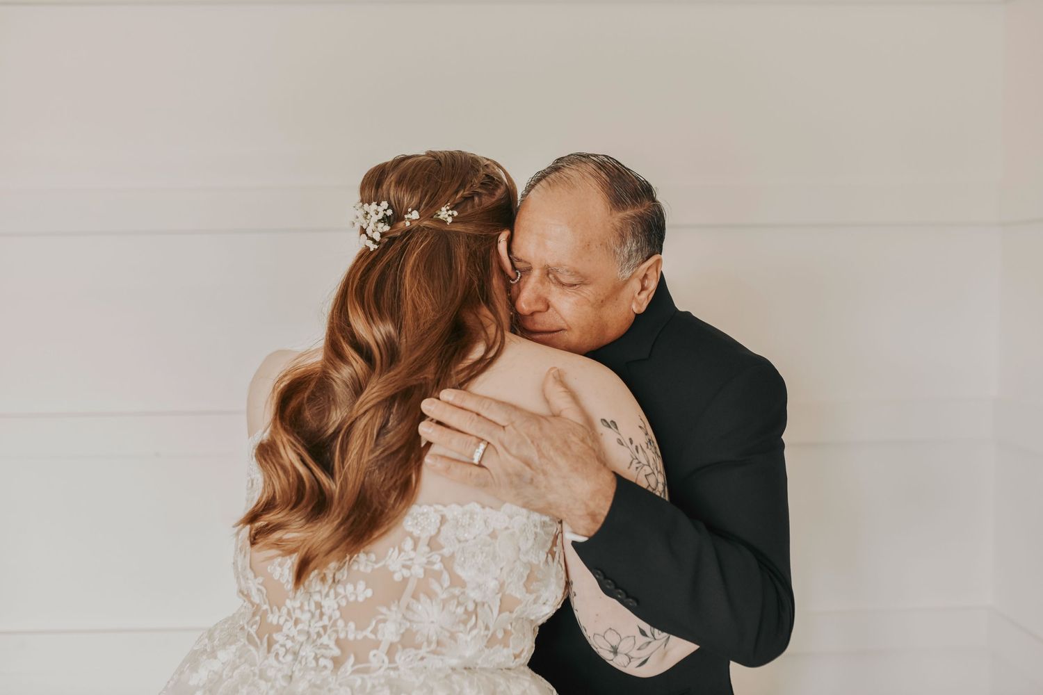 Bride holding her father during a tear-filled first look moment before the wedding ceremony