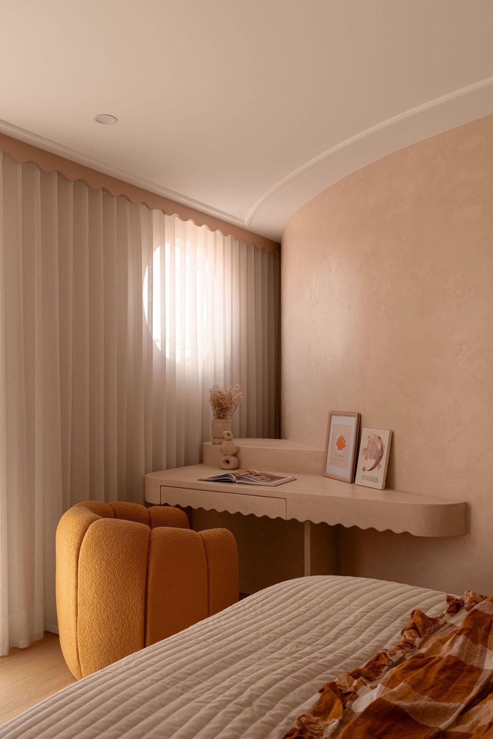 A modern minimalist bedroom interior with vertical blinds, beige walls, and a mustard yellow upholstered headboard.