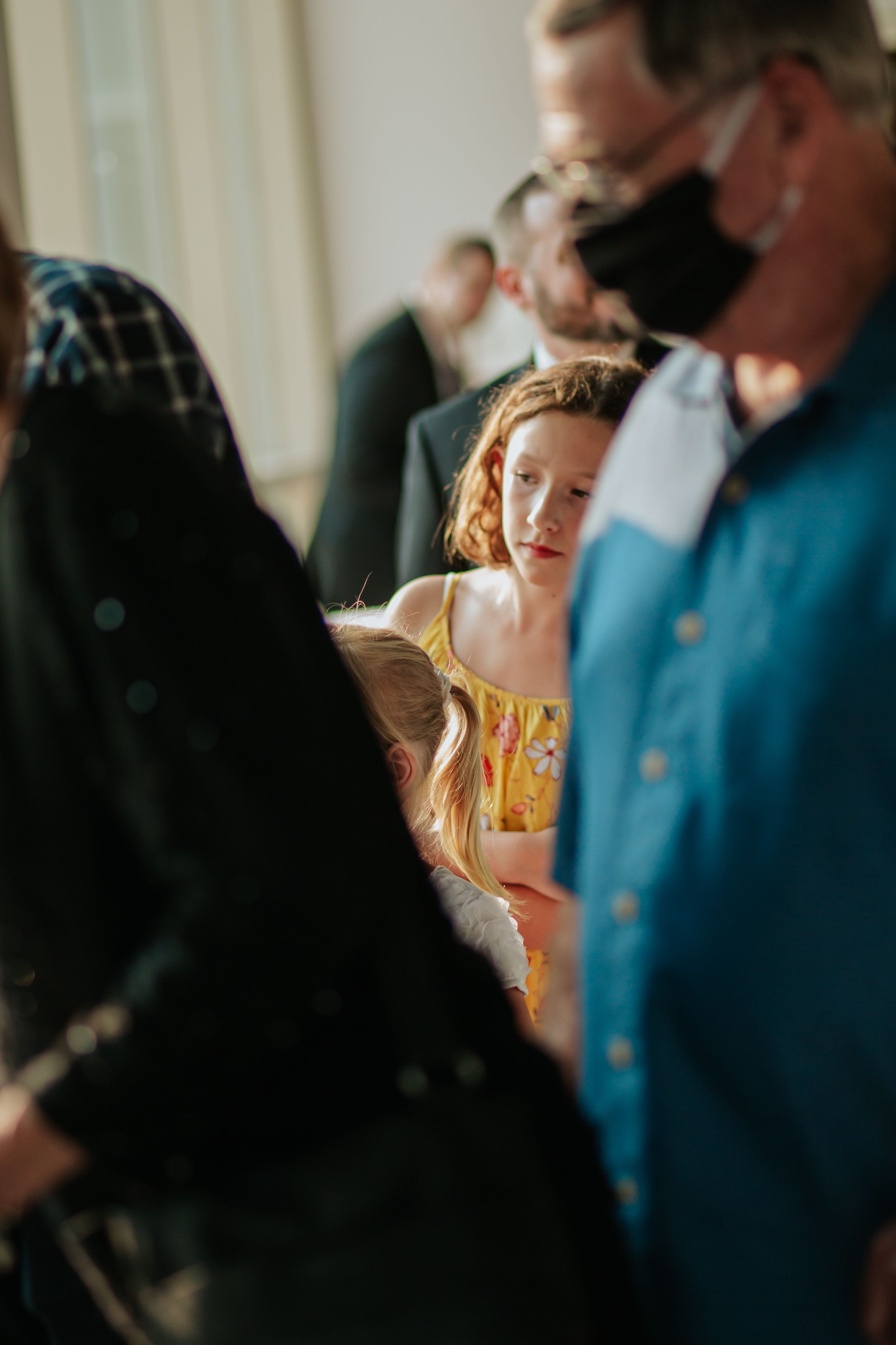 A series of four sequential images showing people in conversation with soft lighting and shallow depth of field.