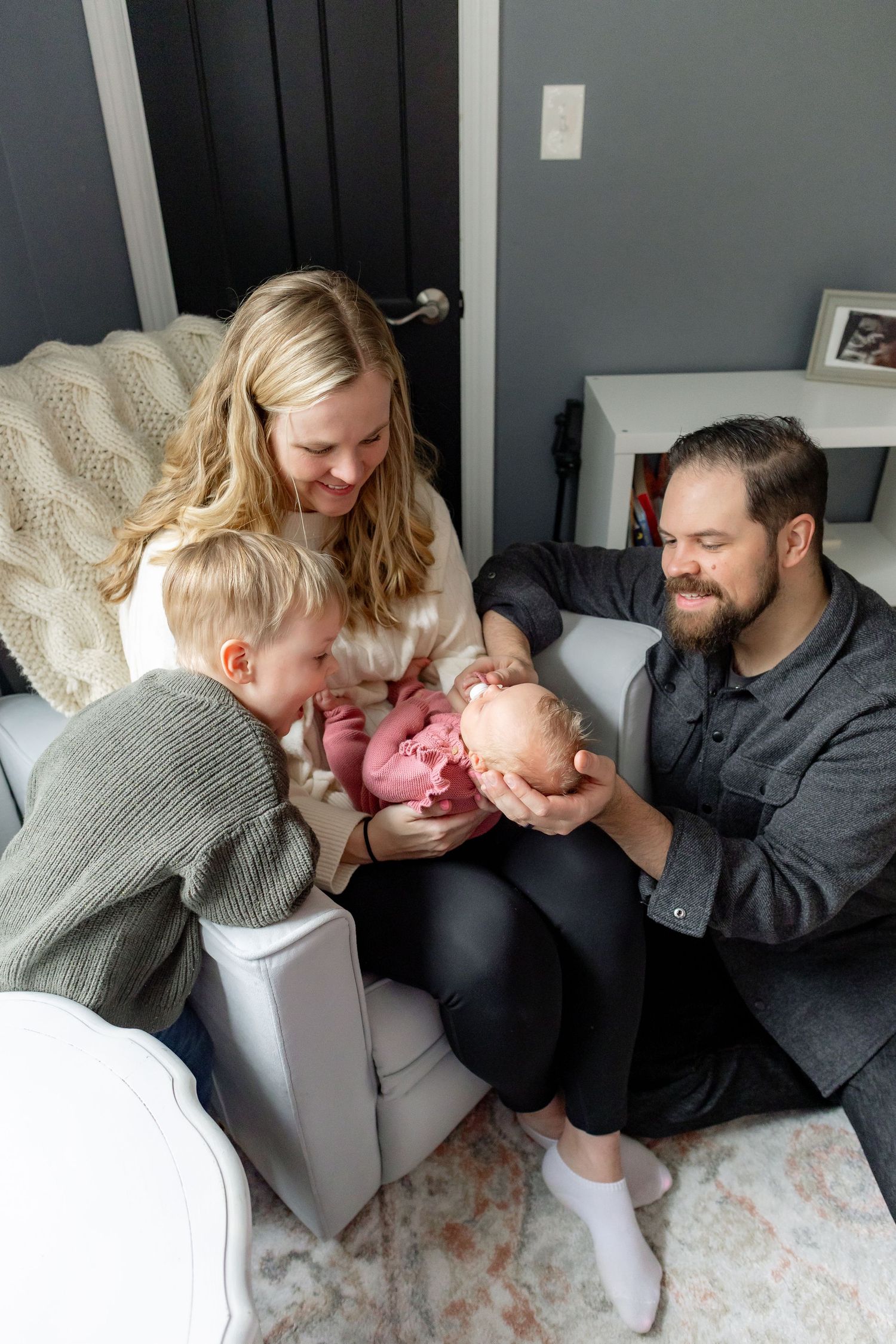A family shares tender moments together on a gray couch, showing affection and laughter in a sequence of candid shots.
