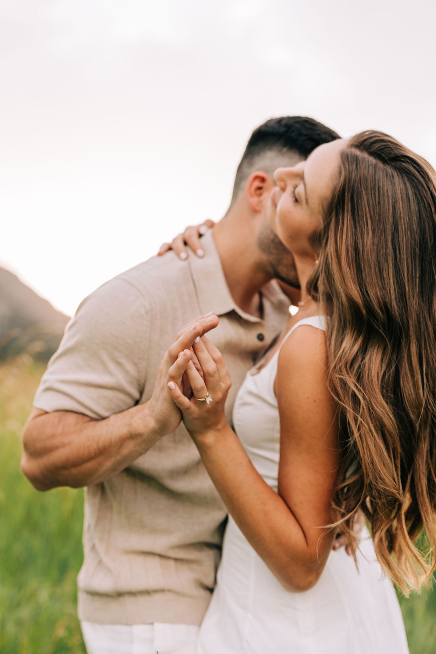 Boulder engagement session. An intimate moment of a couple slow dancing with the flat irons in the background as the sun sets