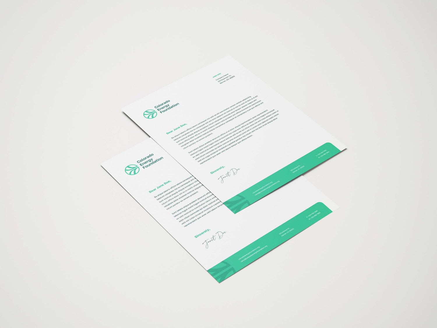 Clean business stationery mockup featuring letterhead and documents with green accent bars.
