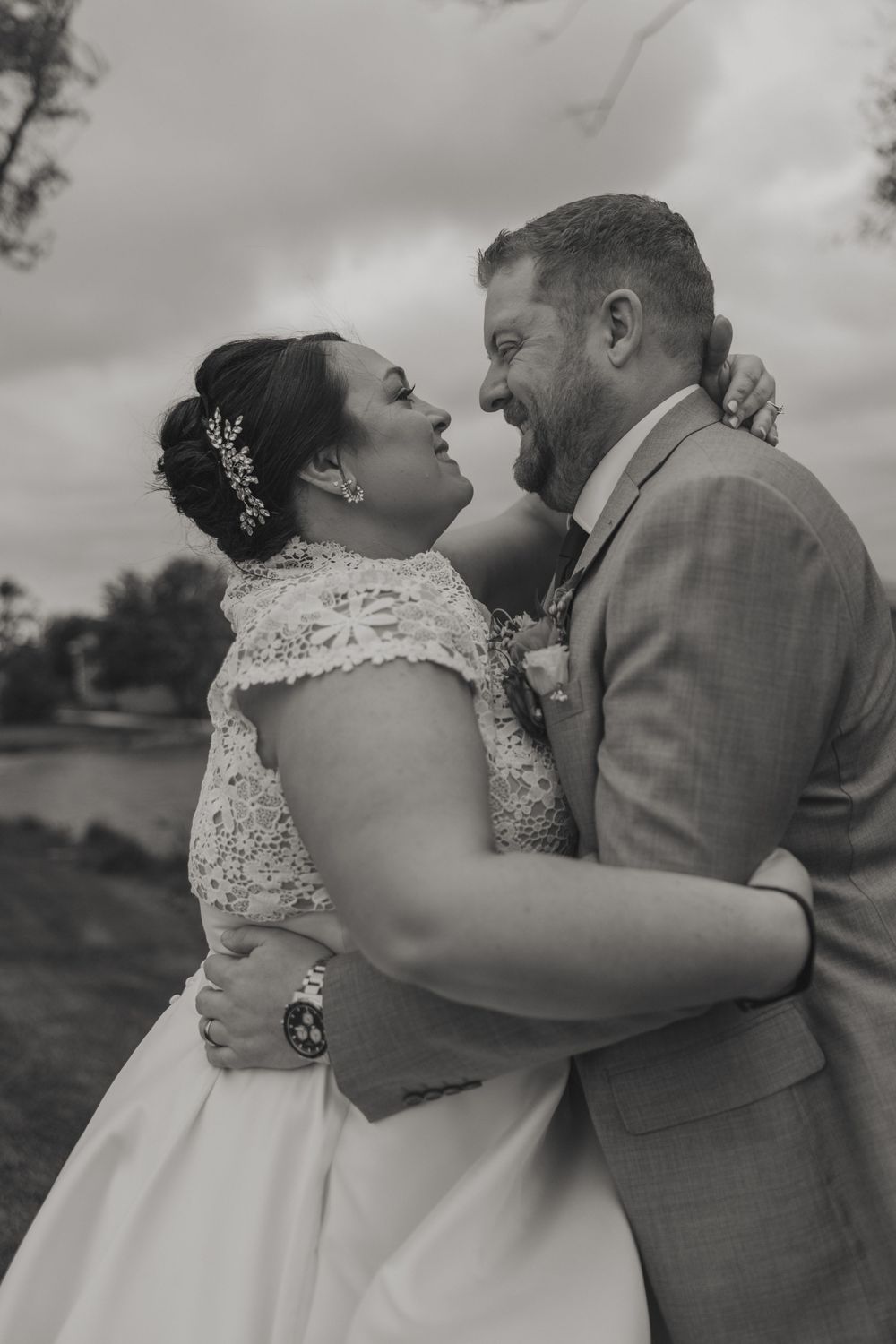 A sequence of black and white wedding photos showing a romantic moment between a couple outdoors.