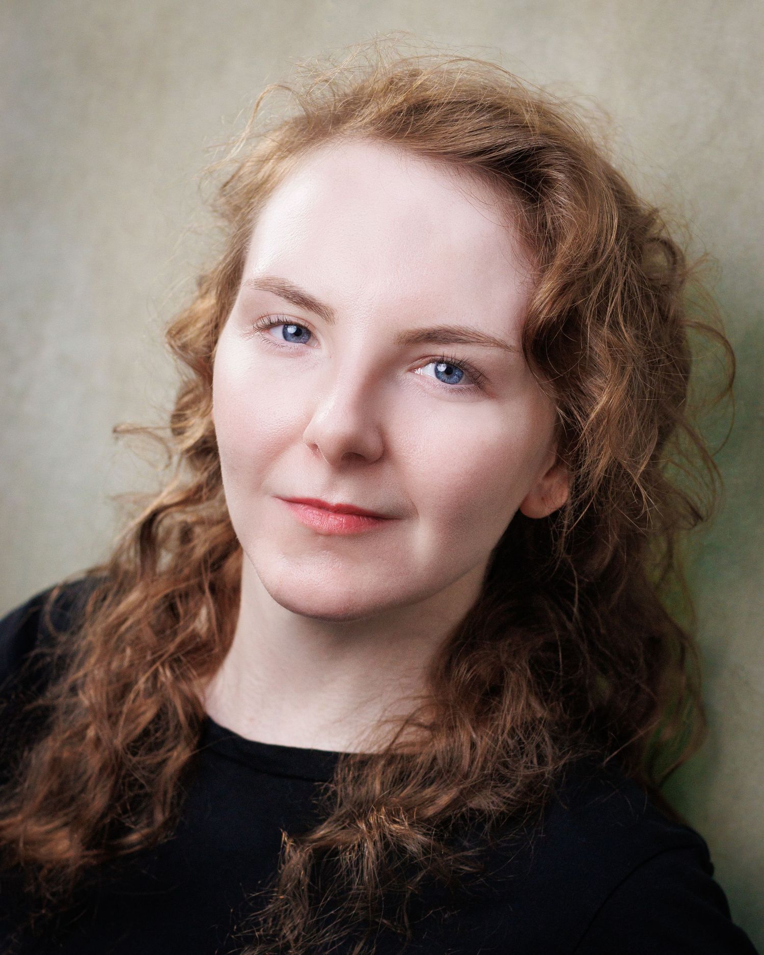 A portrait series showing expressive poses with flowing red curly hair against a neutral backdrop.