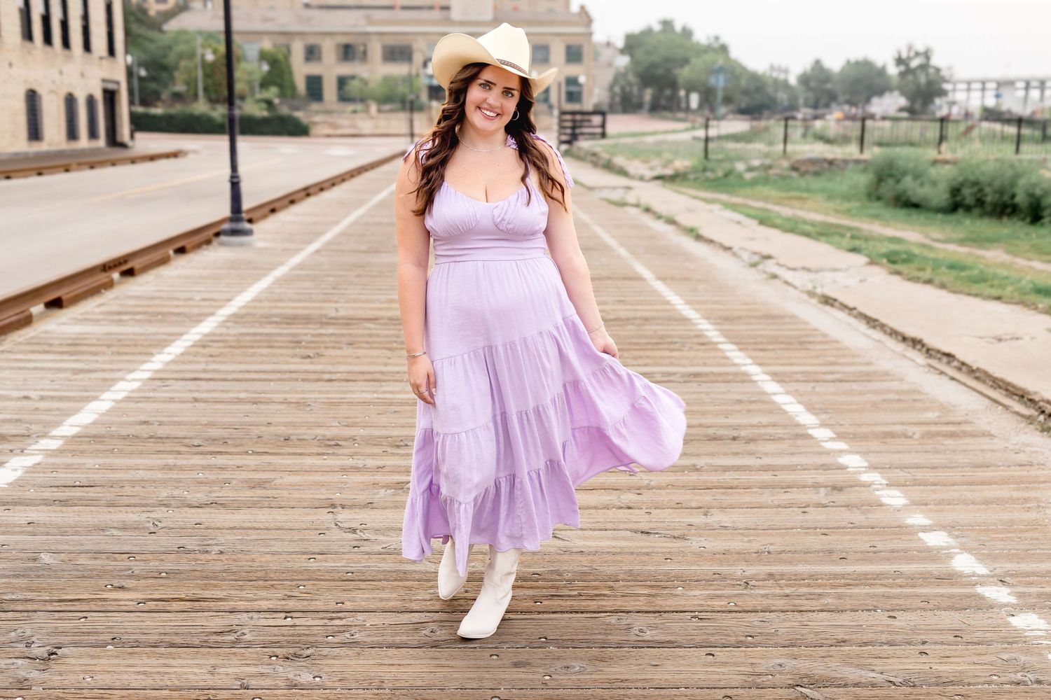 Lifestyle photos on wooden boardwalk wearing light purple summer dress.