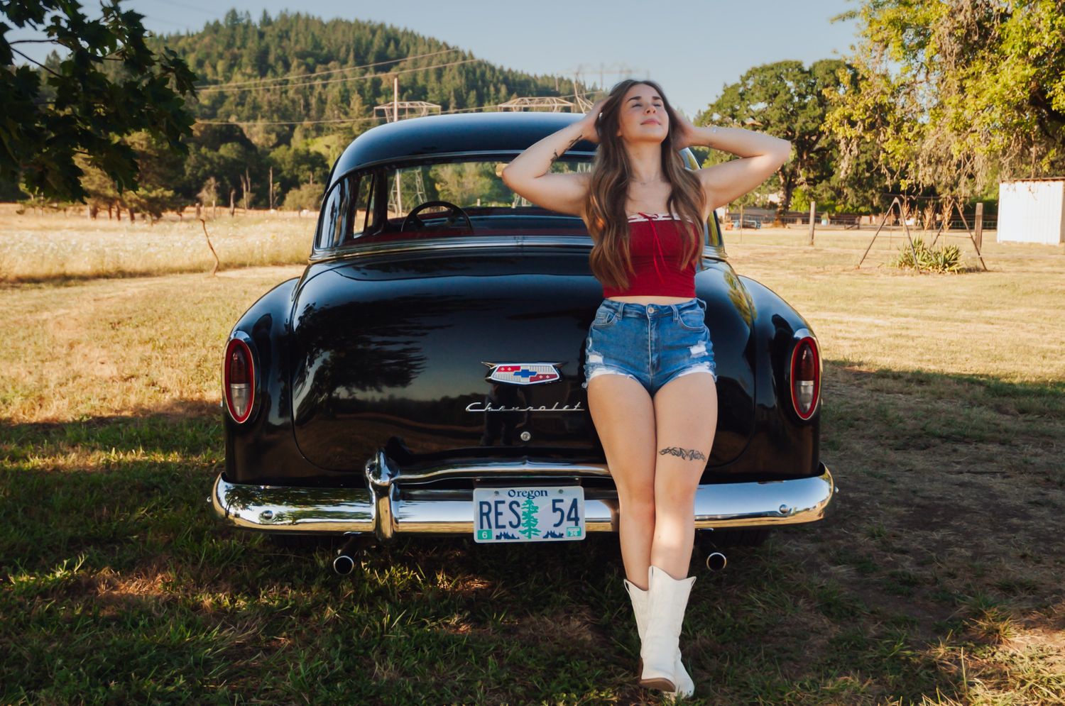 Leaned up against a classic Chevy car, this girl knows how to strike a pose.
