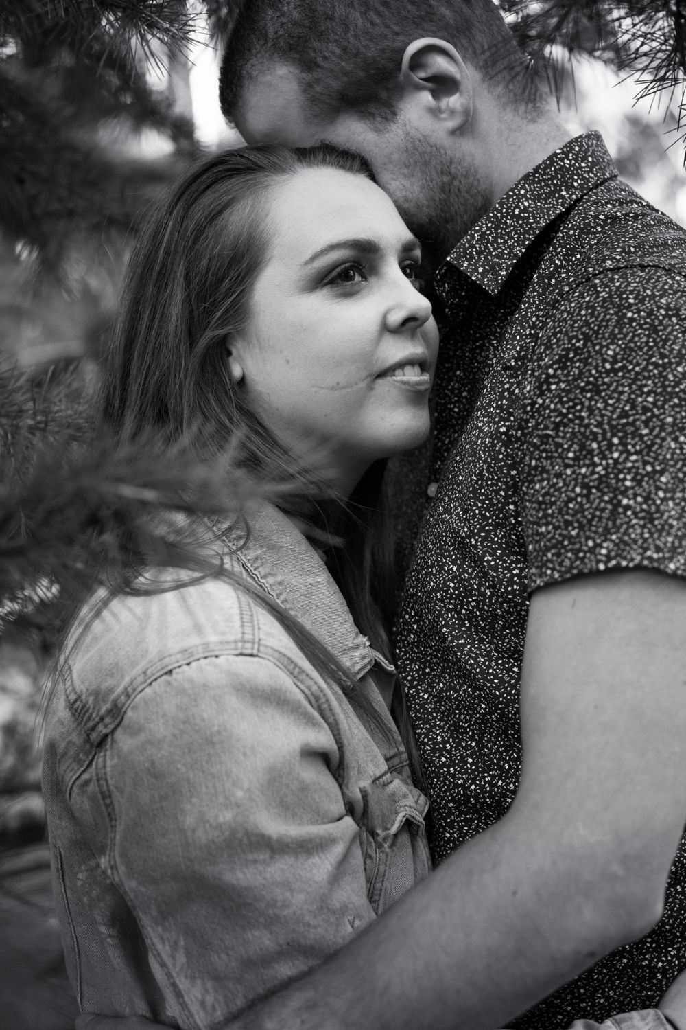 Intimate black and white portrait showing tender moment between couple during their engagement session.