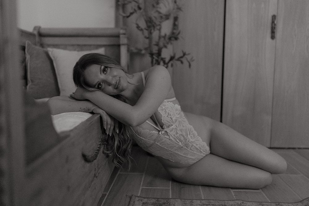 Black and white photo collage showing a reclining figure in six complementary poses against a soft background.