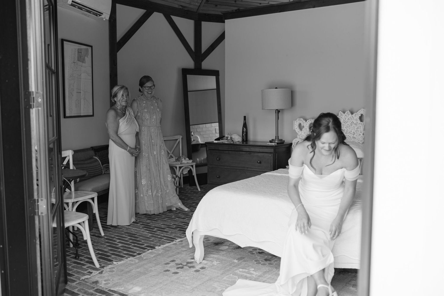 A vintage black and white hospital room scene shows caregivers and patients in a medical setting from the past.