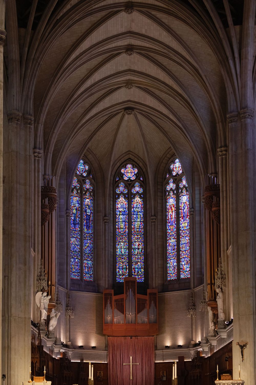 Panoramic view of a cathedral interior showing ornate gothic arches and stained glass windows.
