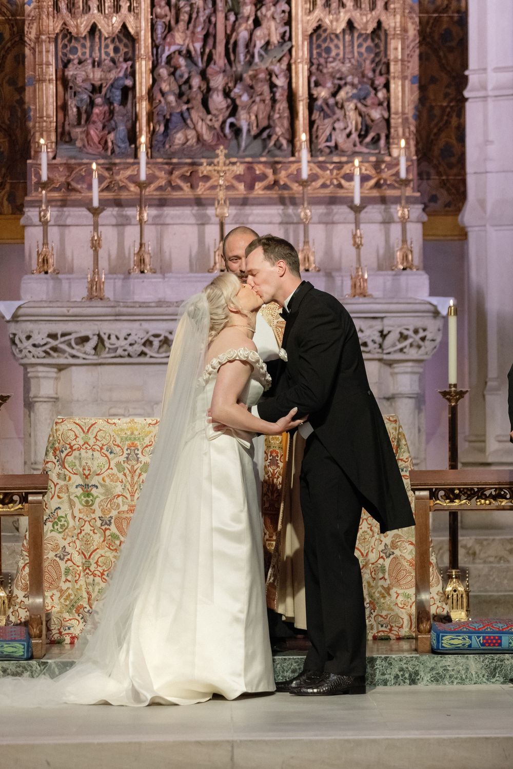 Romantic wedding couple sharing intimate moments at the church altar.