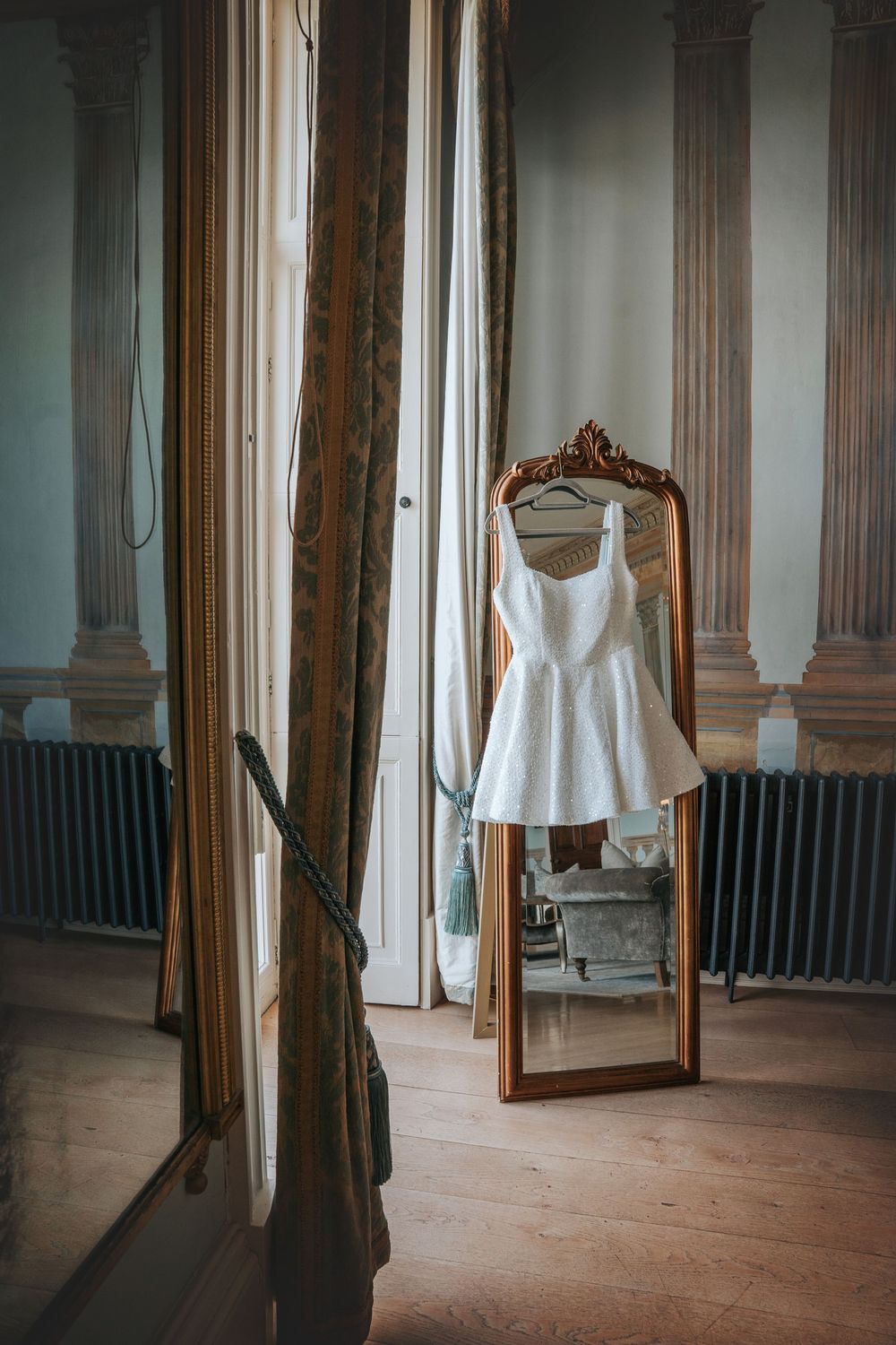 Bridal gown hanging in the preparation suite at Rockbeare Manor