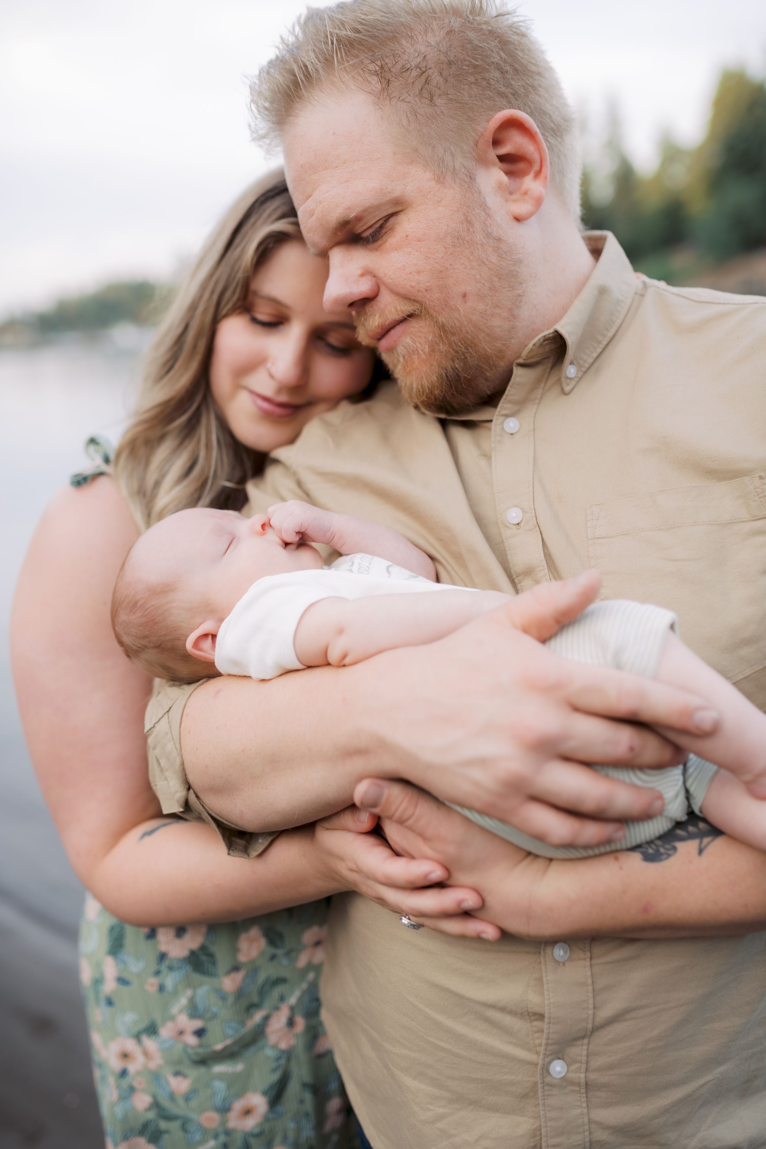 Sweet series of tender moments showing parents cuddling and bonding with their newborn baby outdoors.