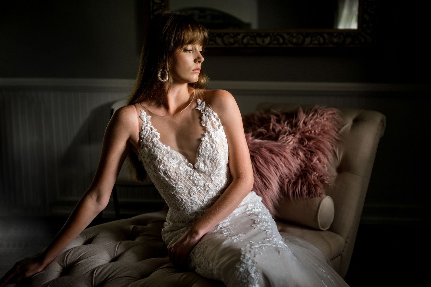 Dramatic indoor bridal portraits with moody lighting and elegant decor.