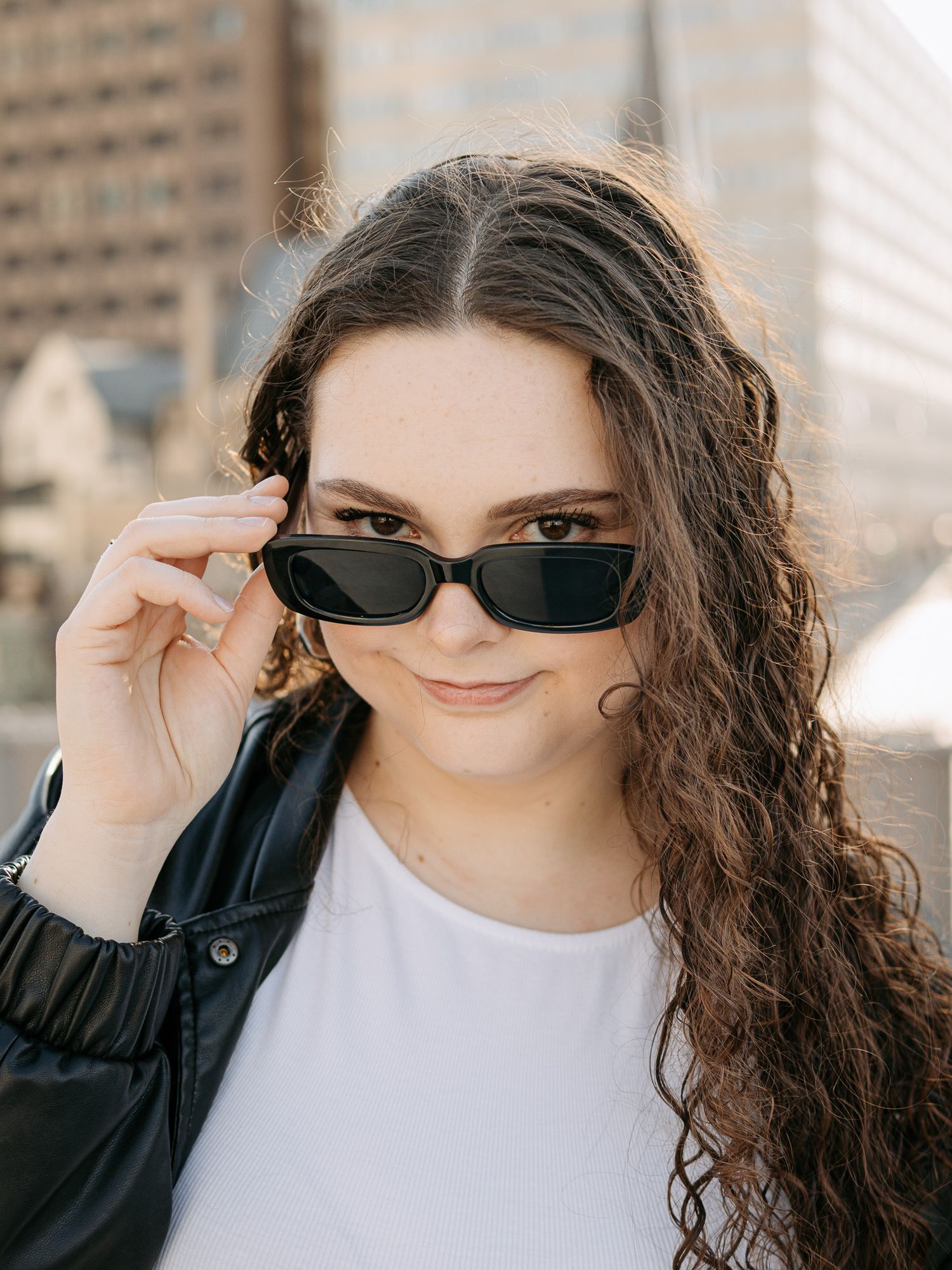 headshot on a parking garage rooftop