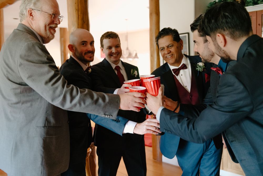 A series of photos showing people in suits hugging and embracing at what appears to be a formal event or celebration.