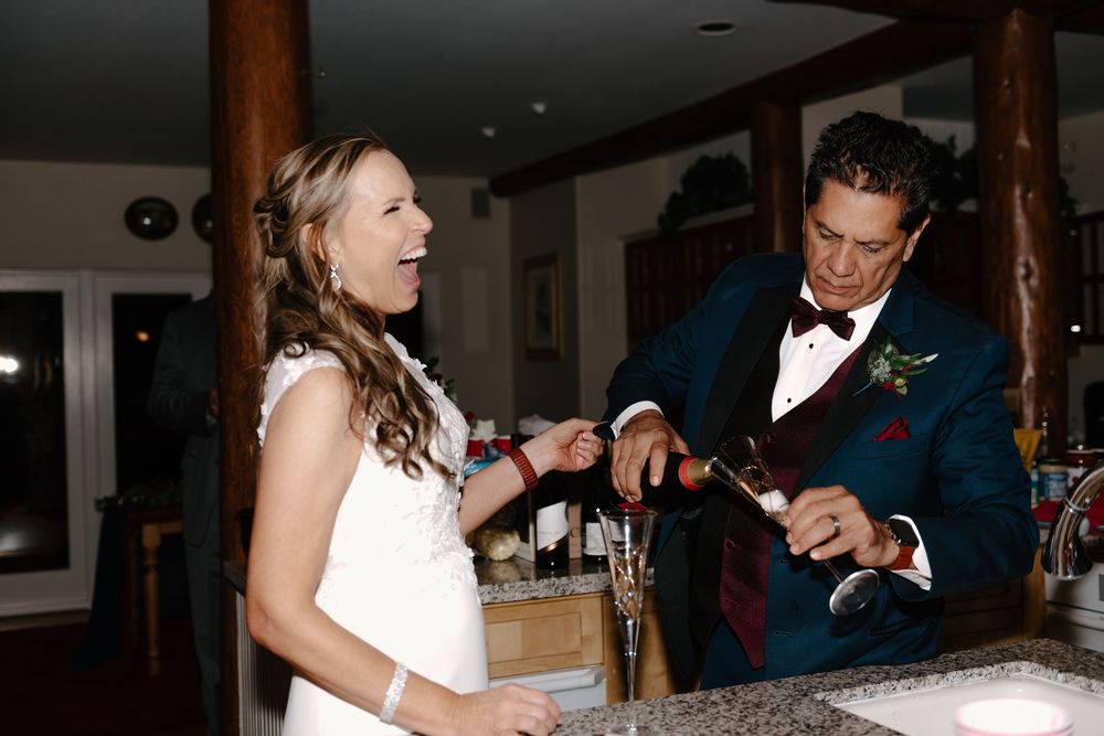 A bride and groom share intimate moments during their wedding reception at an elegant indoor venue.