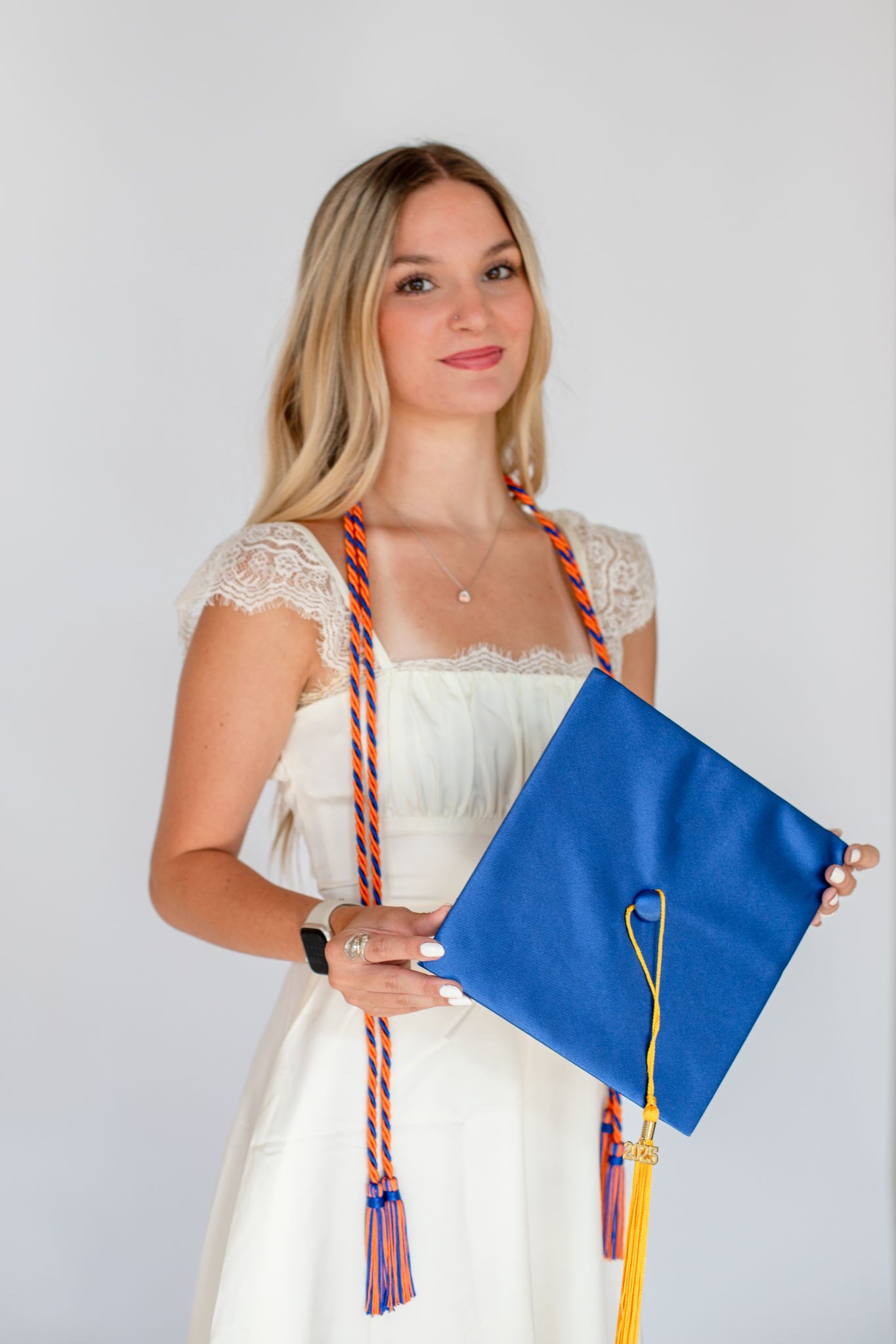 Graduate photo in Cincinnati studio with cap and gown for luxury senior portrait clients
