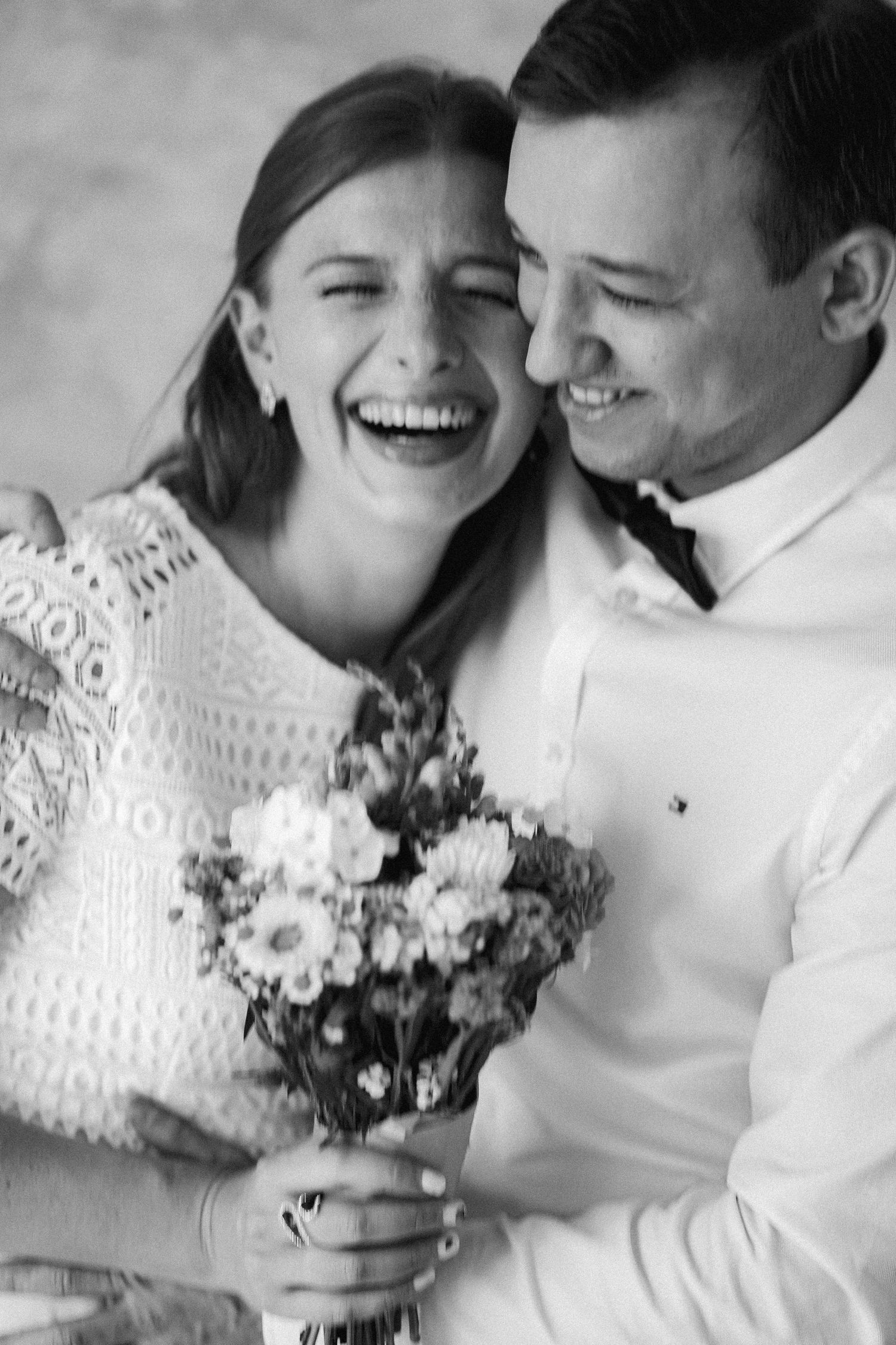 Black and white photo series of couple laughing joyfully with wedding flowers in romantic candid moments.