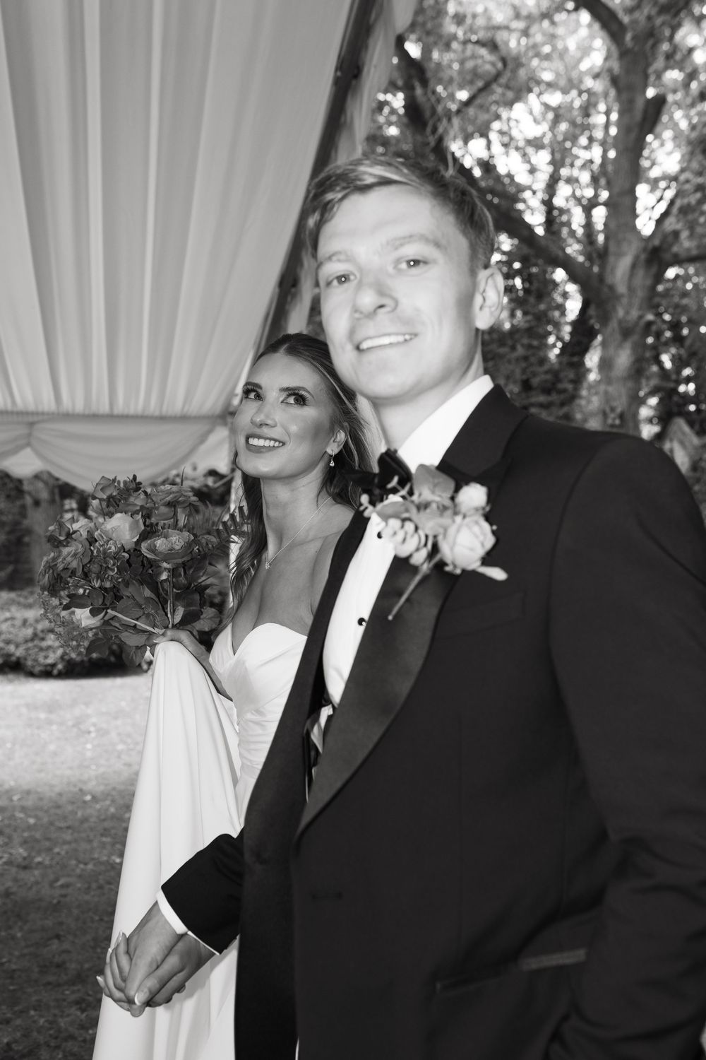 A bride and groom share candid moments in a series of artistic black and white wedding photos outdoors.