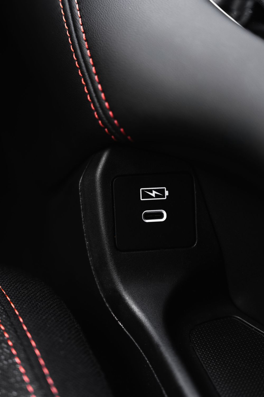 Close-up of car interior button panel with red contrast stitching.Mtlshutter photography